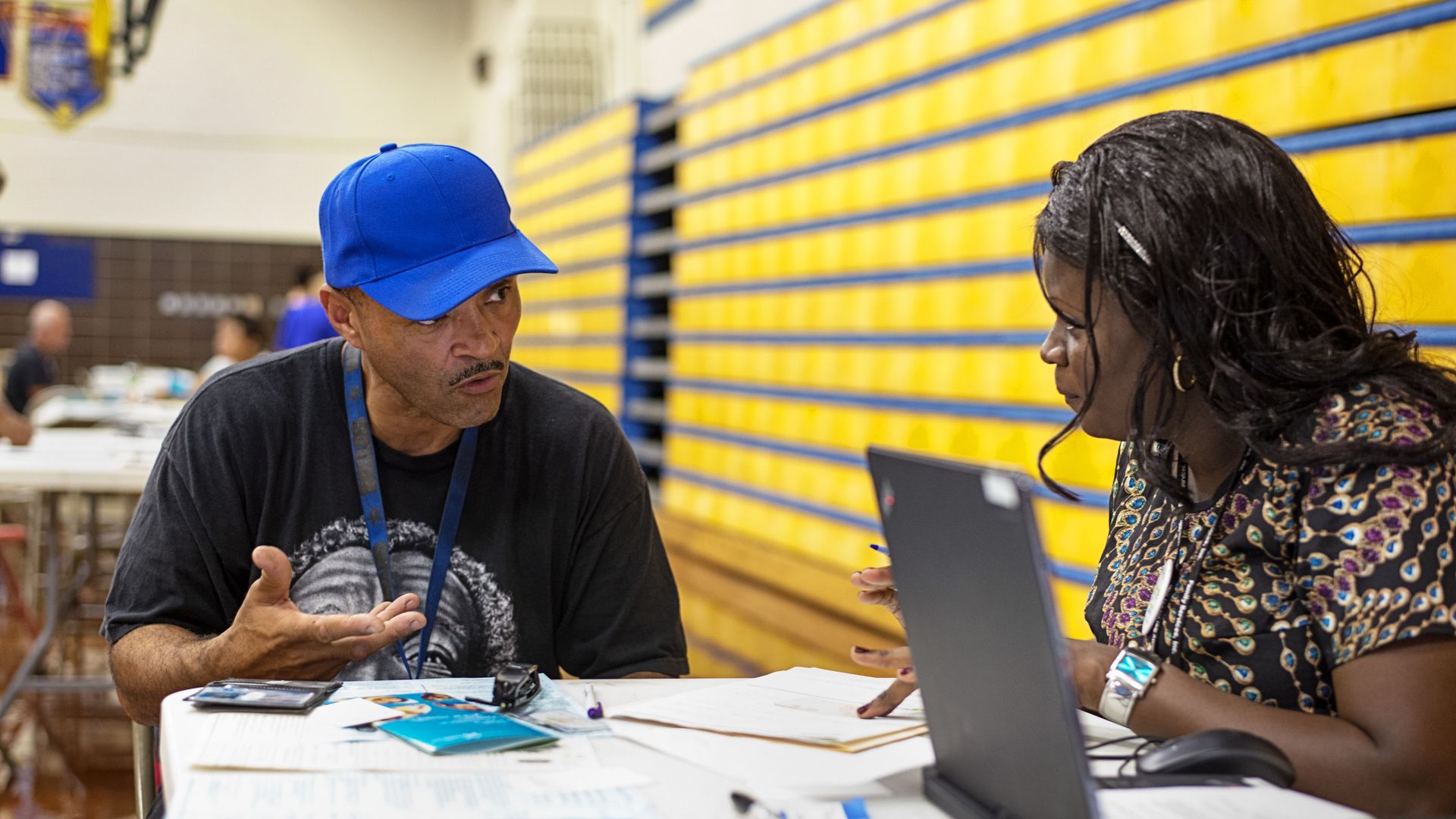 An ACA navigator helps a man sign up for health insurance.