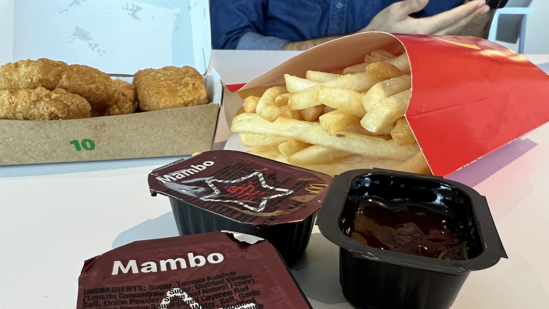 Mambo sauce packets on a table with McNuggets and fries