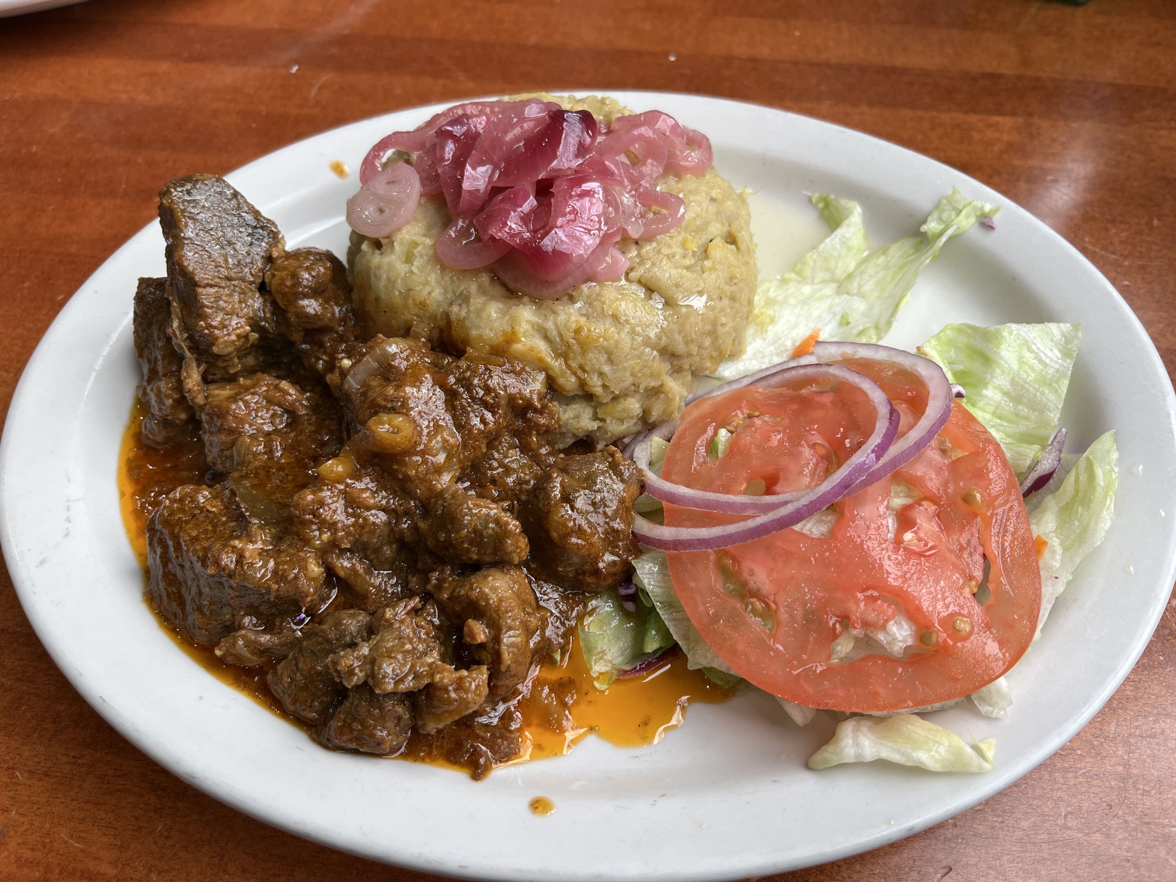 plate of meat stew and mashed plantains.