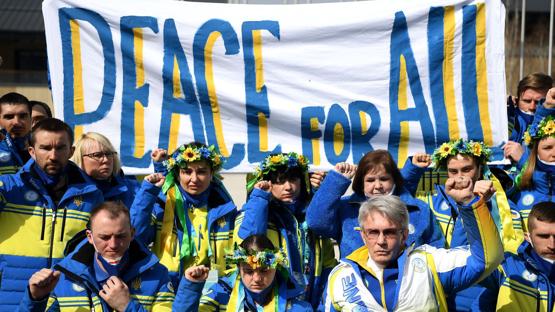 Ukraine's Paralympic Team holds up a "Peace For All" banner in the athletes' village.