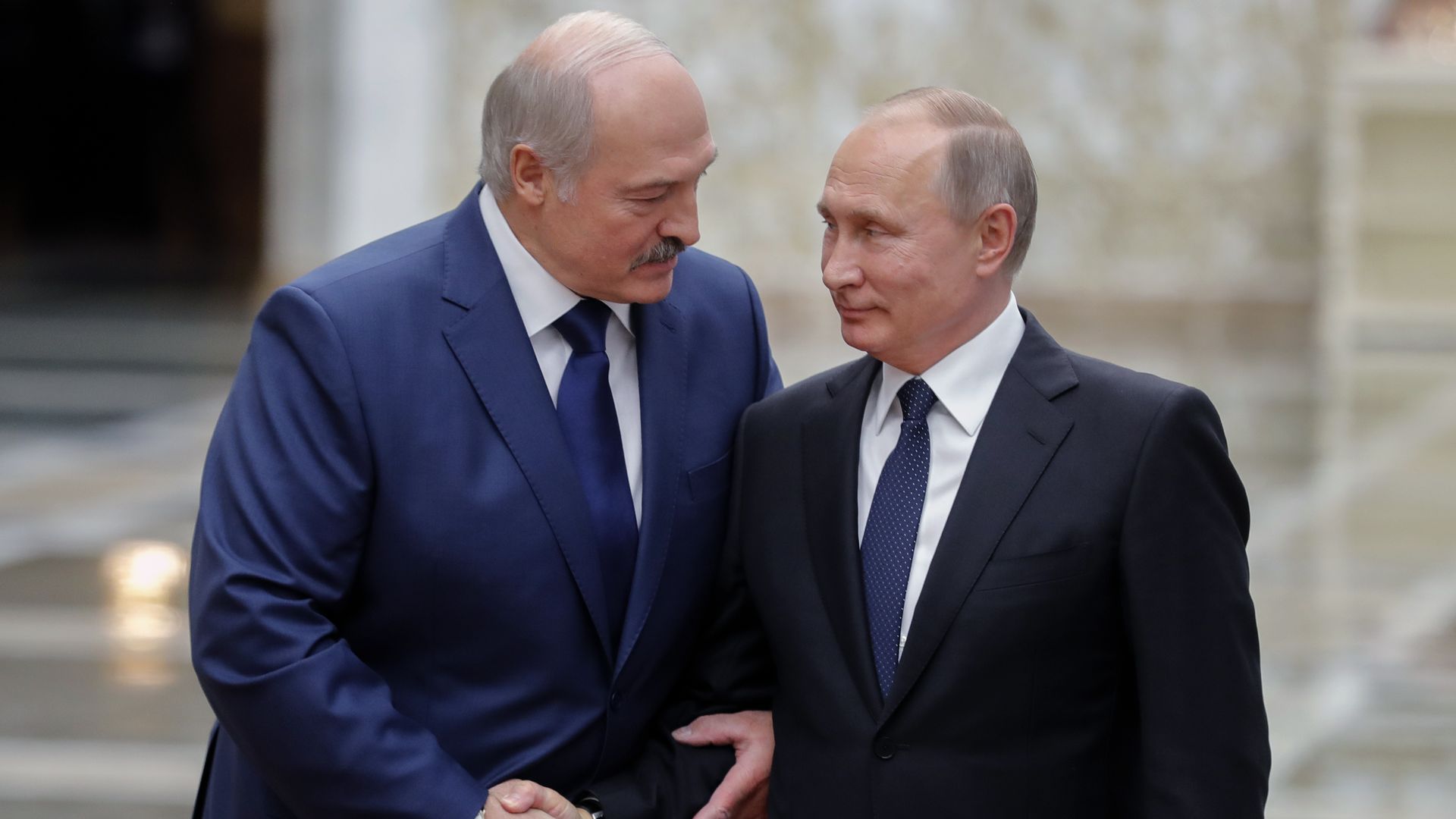 Belarus' President Alexander Lukashenko (L) welcomes his Russian counterpart Vladimir Putin prior to the Collective Security Treaty Organisation in 2017