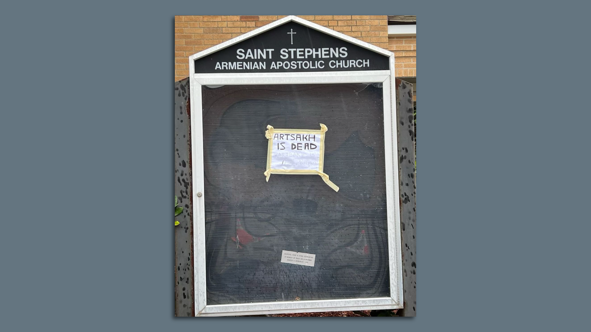 A note taped to St. Stephen's Amernian Apolistic Church's sign that says "Artsakh is dead. Karabakh is Azerbaijan."
