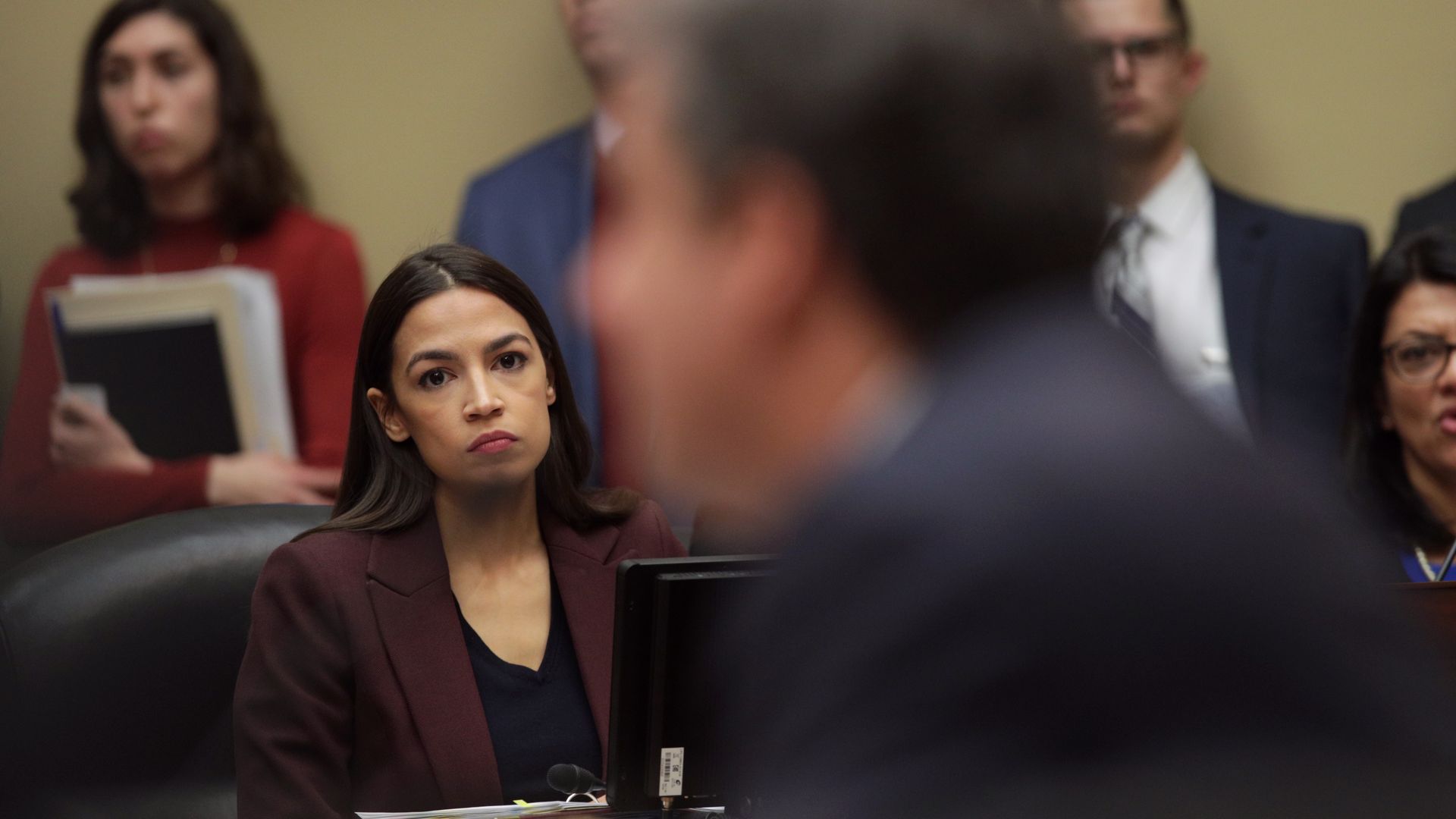 Rep. Alexandria Ocasio-Cortez (D-N.Y.) listens to testimony by Michael Cohen, former attorney and fixer for President Trump. 