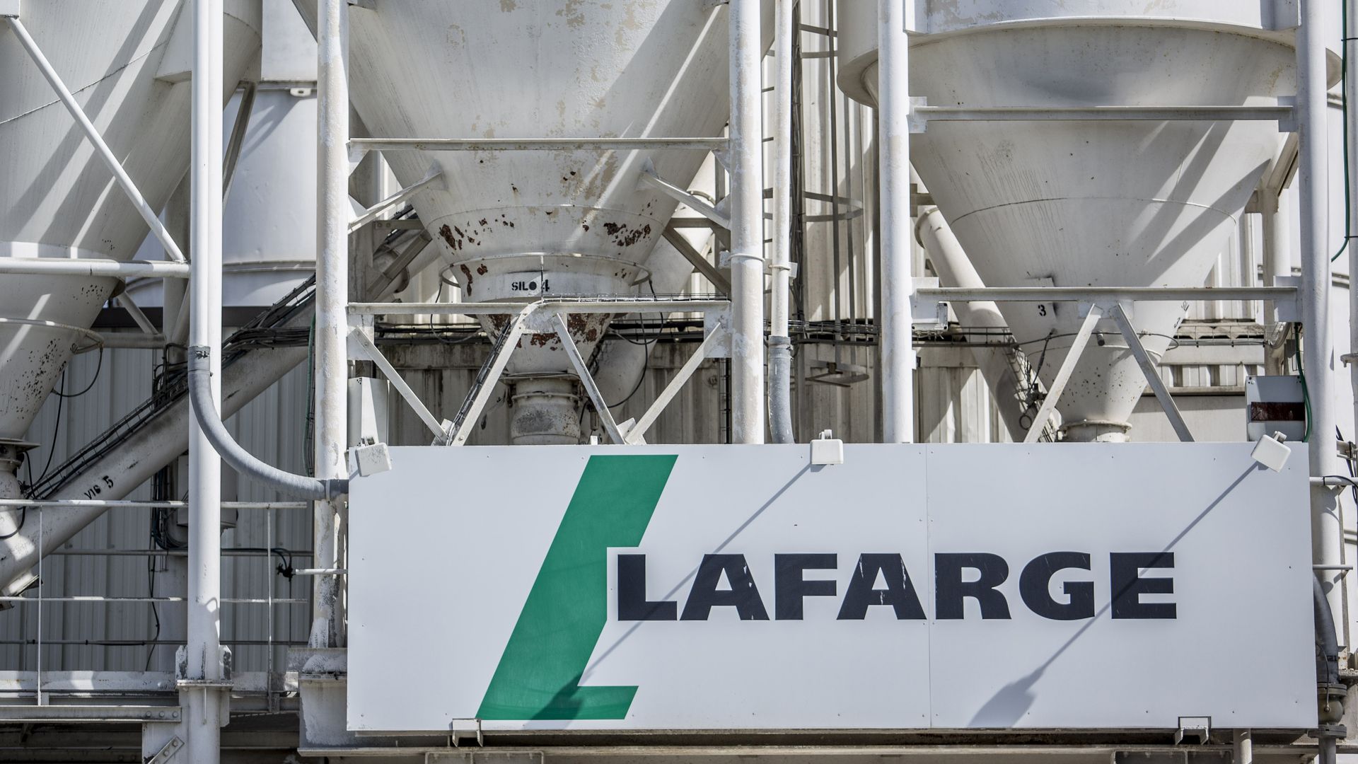 logo of Lafarge SA sits on cement storage silos at the company's distribution center in Albi, France, 