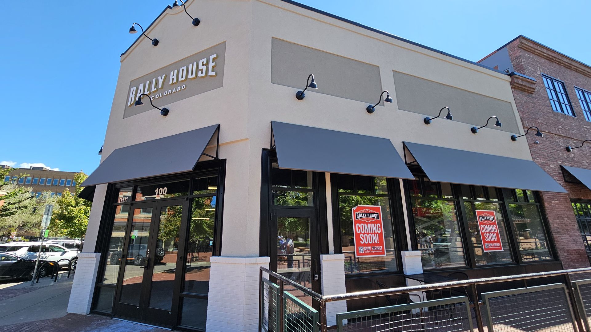 The building at 1346 Pearl St. sits empty, but with signs indicating the coming arrival of Rally House apparel.