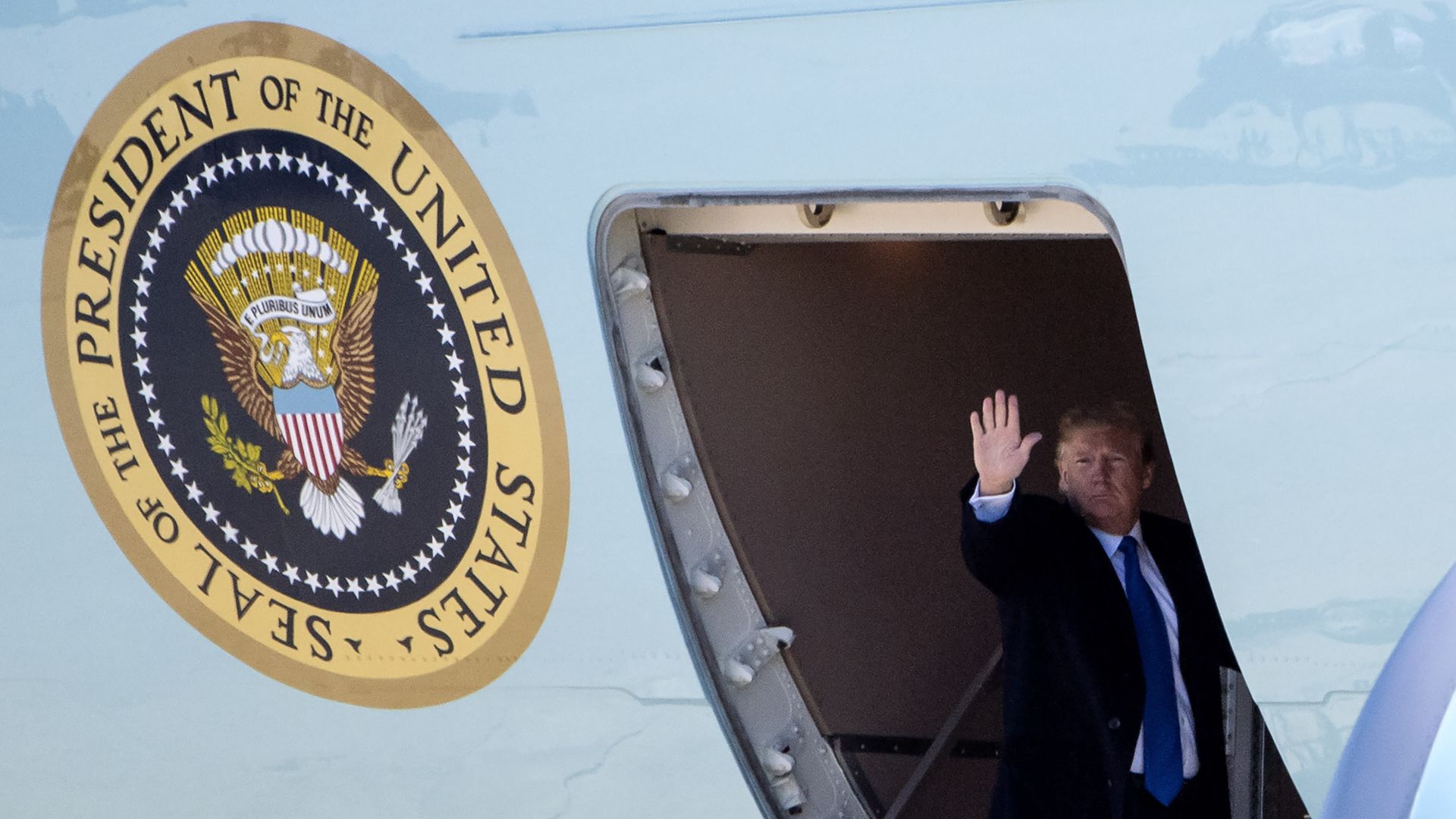 President Donald Trump waves as he boards Air Force One to depart for Vietnam for a summit with North Korean leader Kim Jong Un on February 25, 2019 
