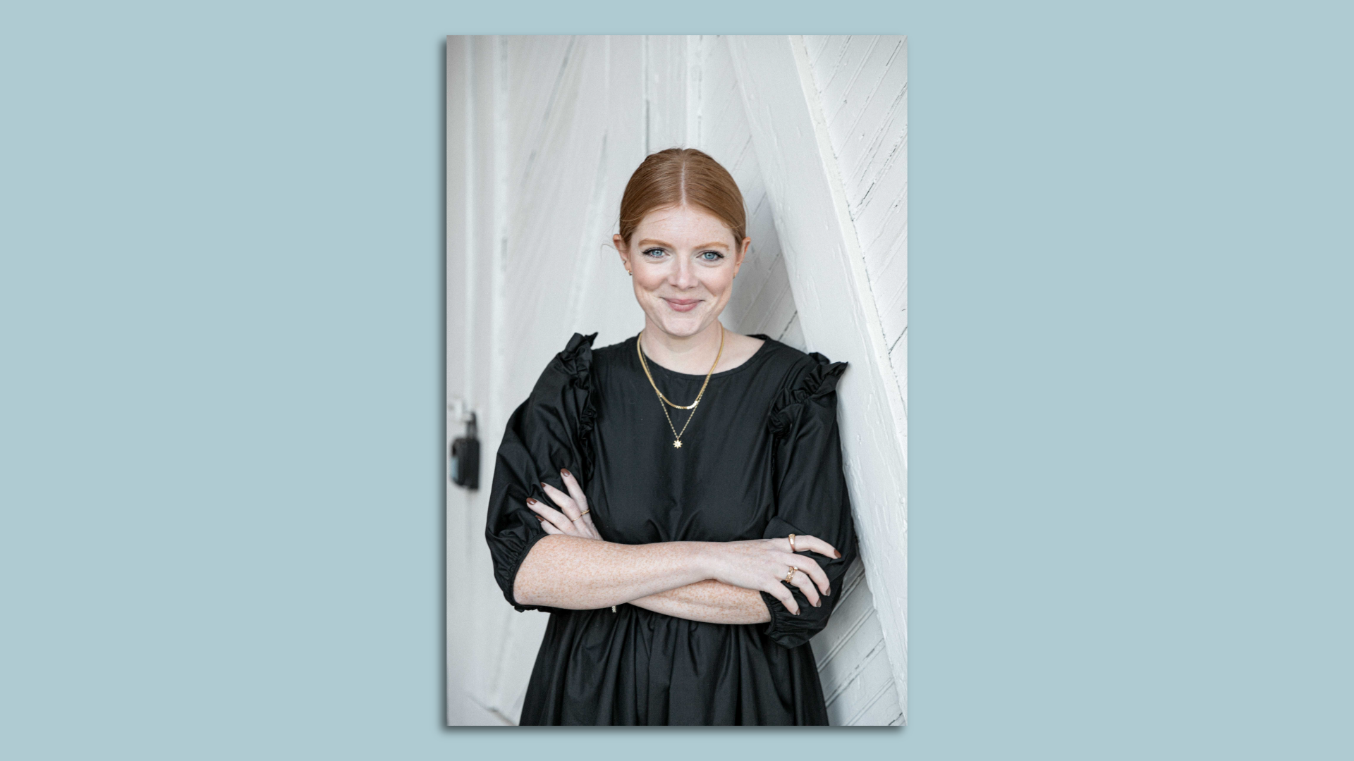 woman smiling and crossing her arms