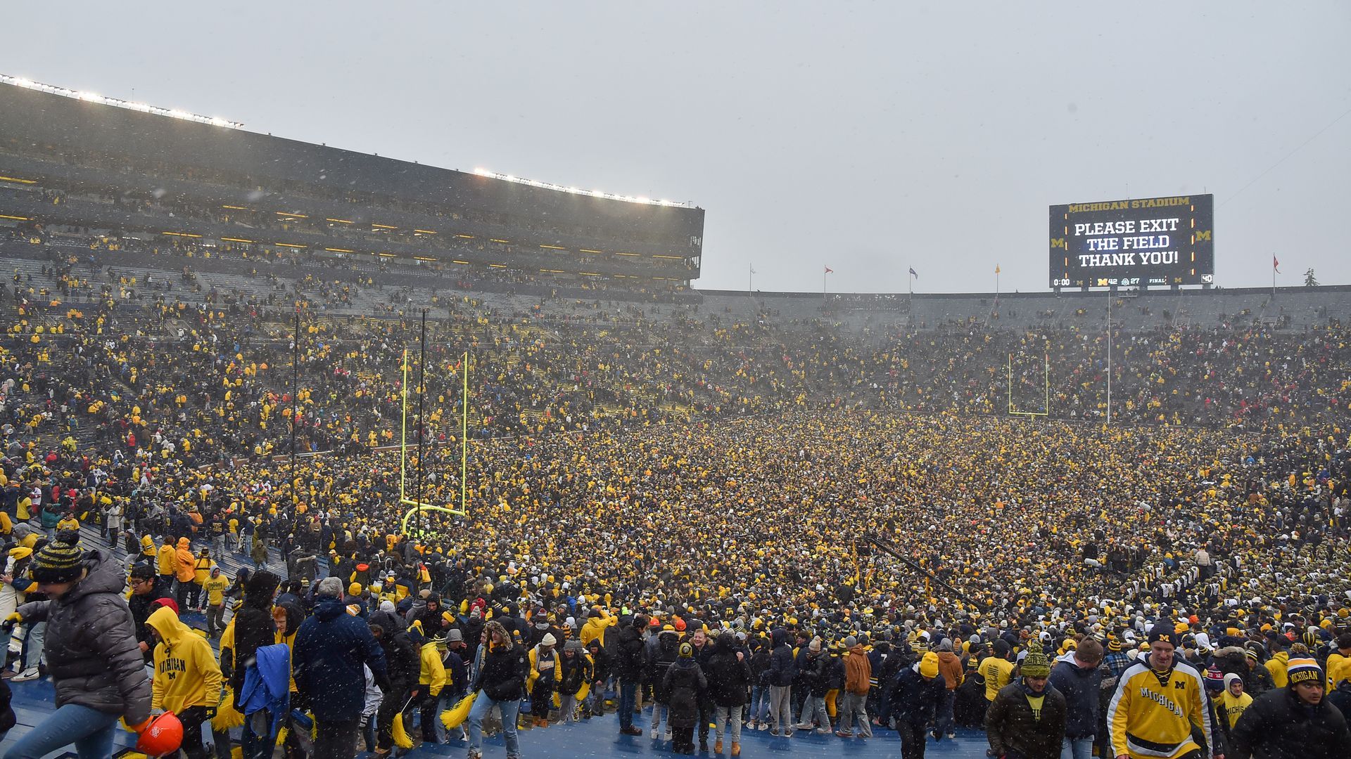 Fans celebrate after Michigan beat Ohio State on Saturday.