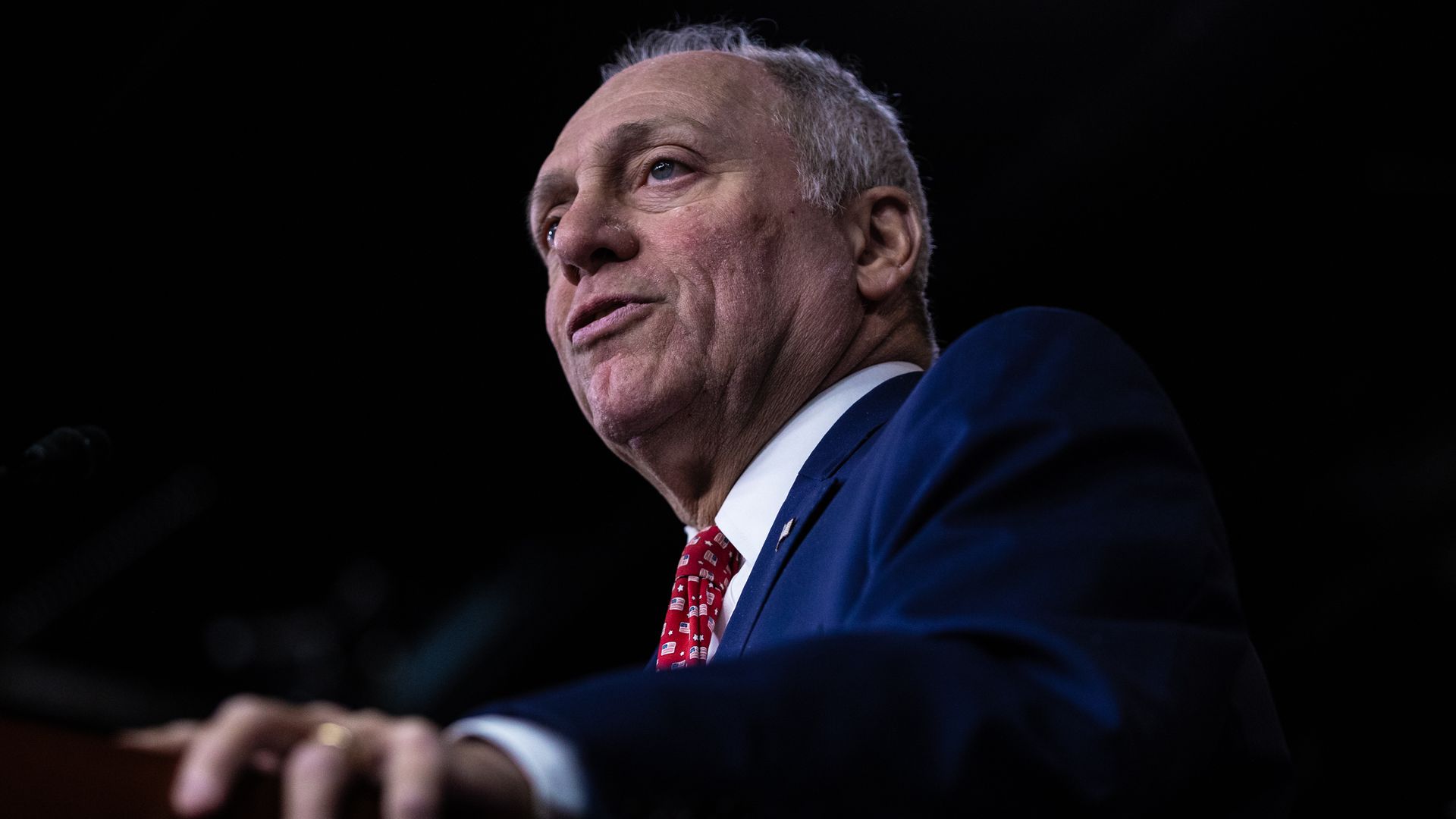 Photo shows House Majority Leader Steve Scalise talks while standing behind a podium.