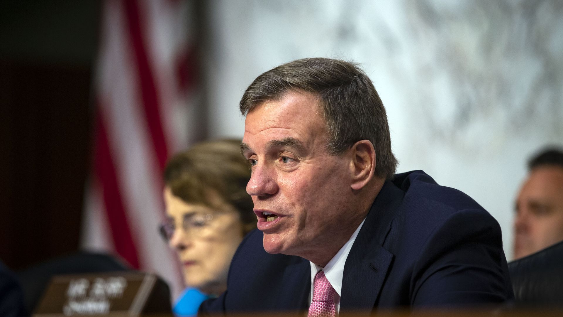 Mark Warner speaking at a hearing.