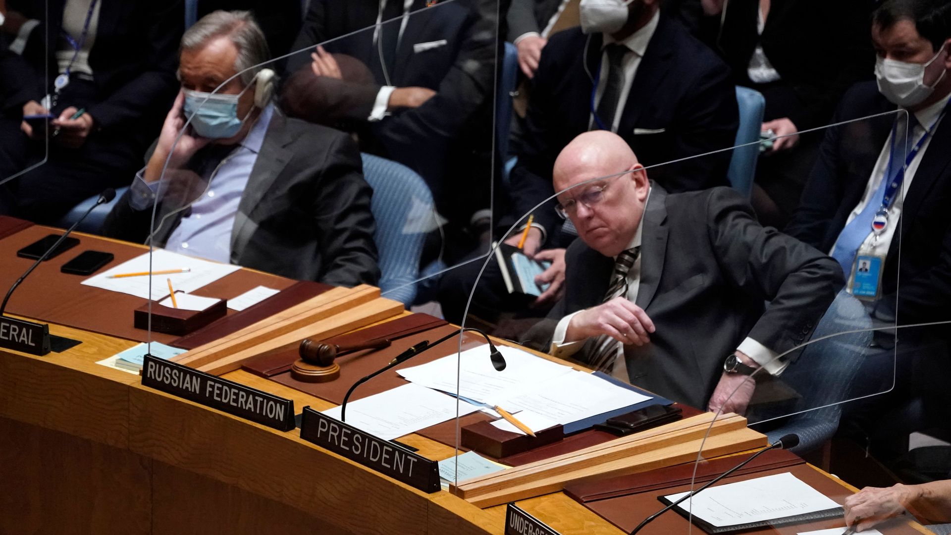 The Russian ambassador to the U.N. is seen sitting next to the U.N. secretary-general.