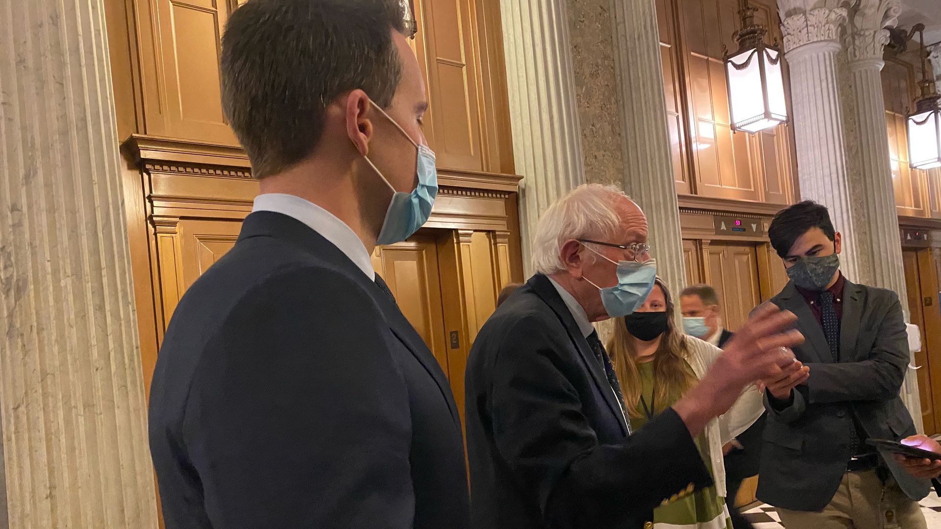 Sens. Josh Hawley and Bernie Sanders talking to reporters in the Capitol.