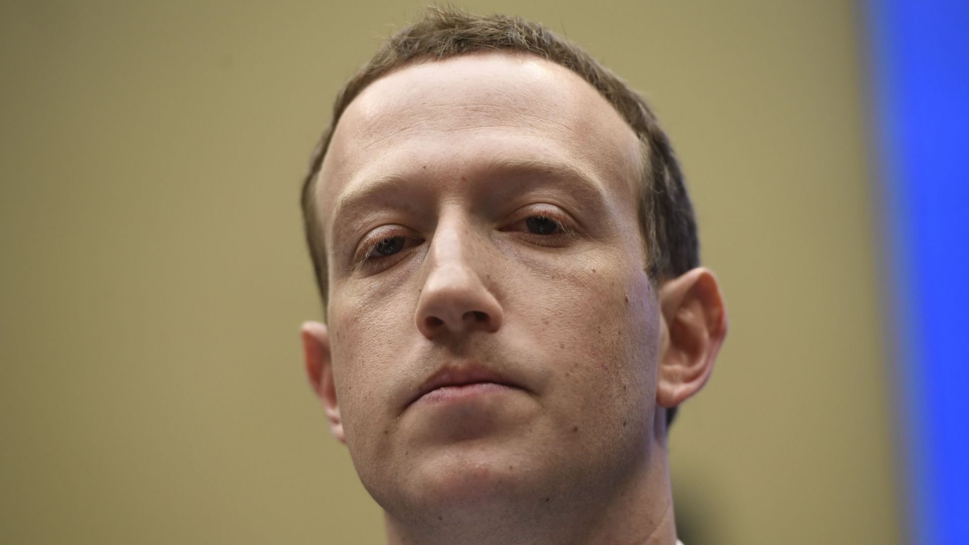 Mark Zuckerberg frowns at a hearing