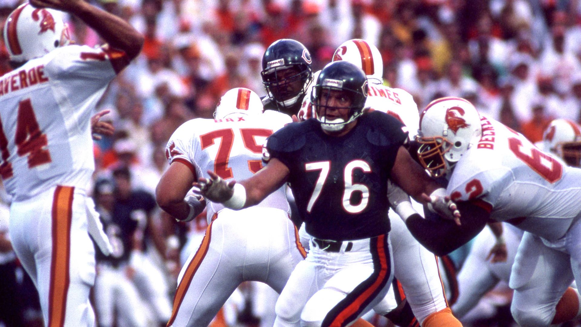 Photo of a football player rushing a quarterback 