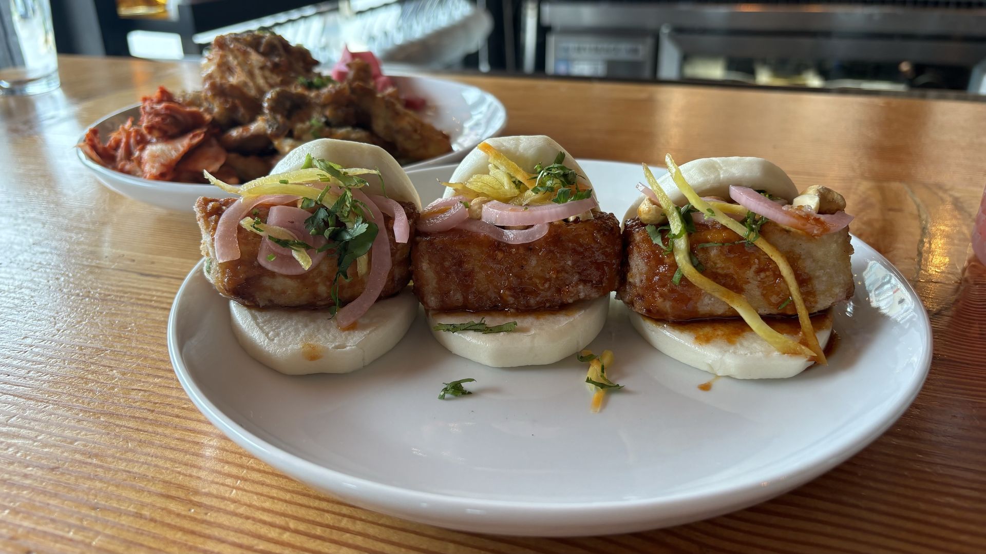 A plate of tofu bao buns. 