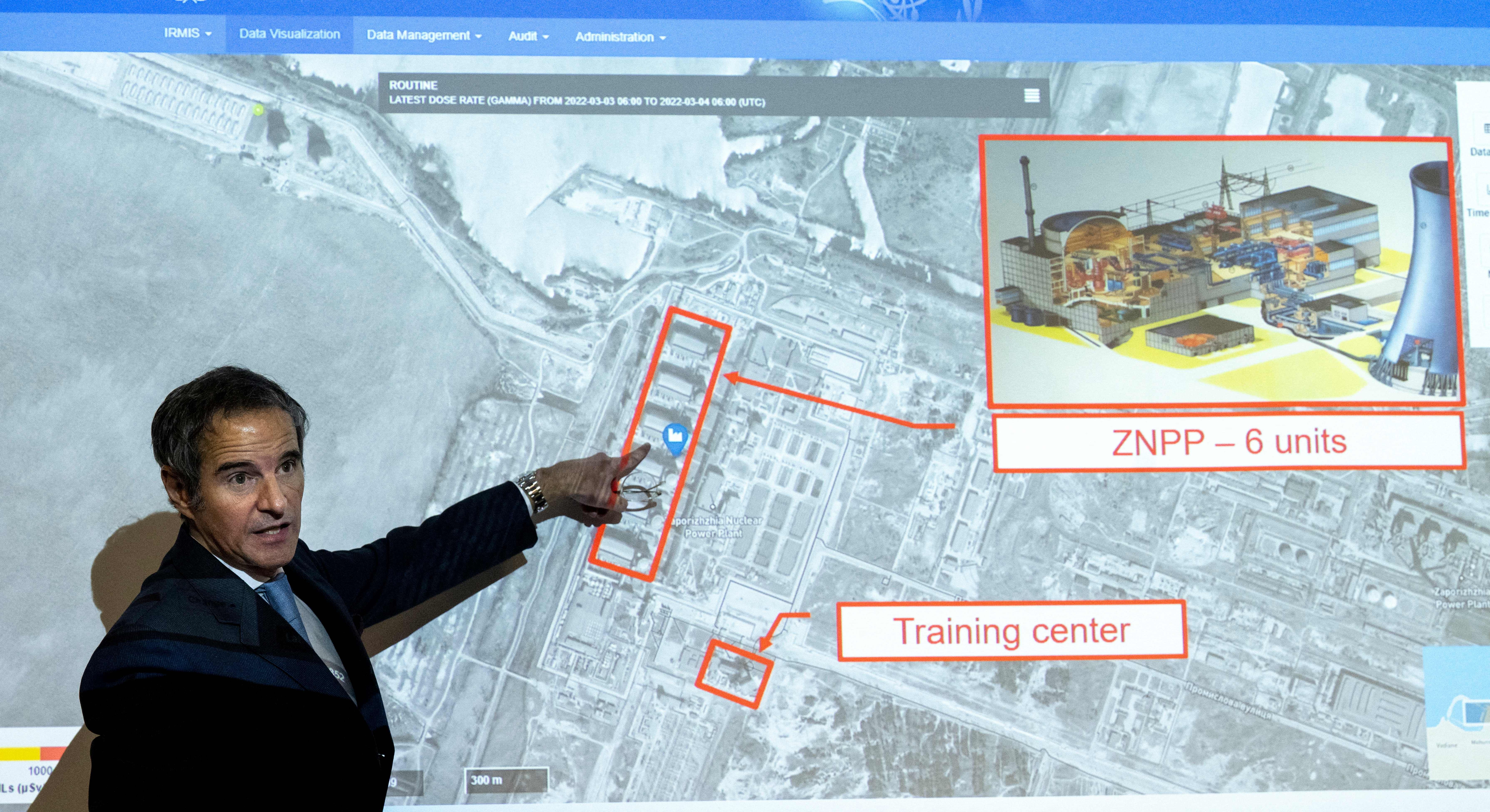 Rafael Grossi, Director General of the International Atomic Energy Agency, in Austria points on a map of the Ukrainian Zaporizhzhia nuclear power plant in Ukraine.