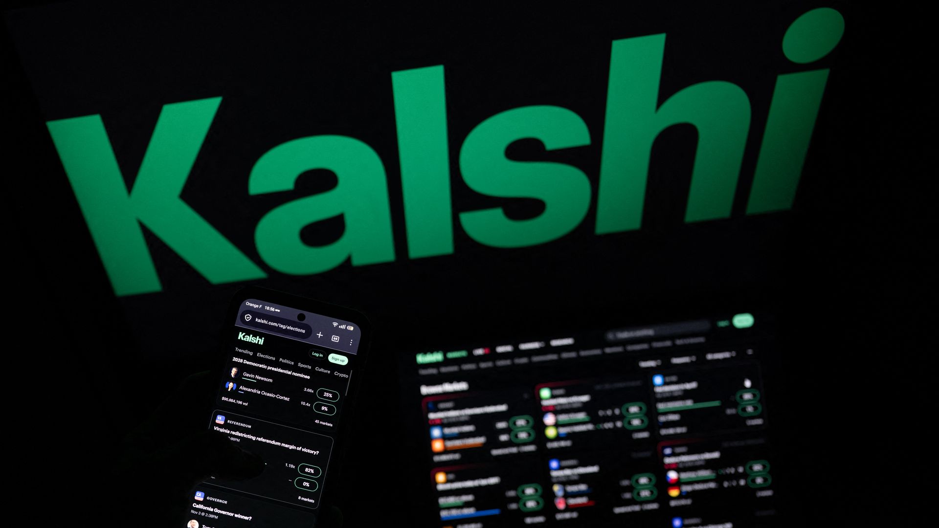 Dark background with a large lime-green 'kalshi' logo across the scene; in the foreground, a smartphone screen shows the Kalshi app interface with lists and small profile icons.