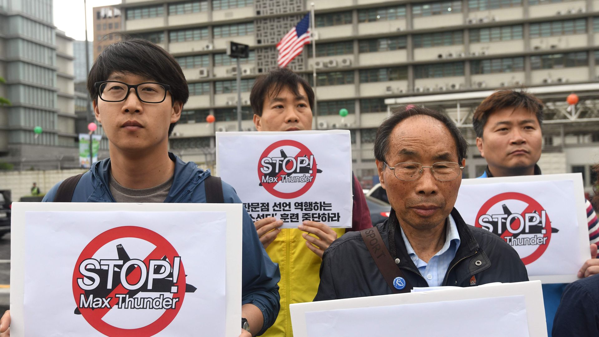 South Korean peace activists hold placards reading 'Stop! Max Thunder,' during a rally denouncing South Korea-US joint military drills, in front of the US embassy in Seoul on May 16, 2018.