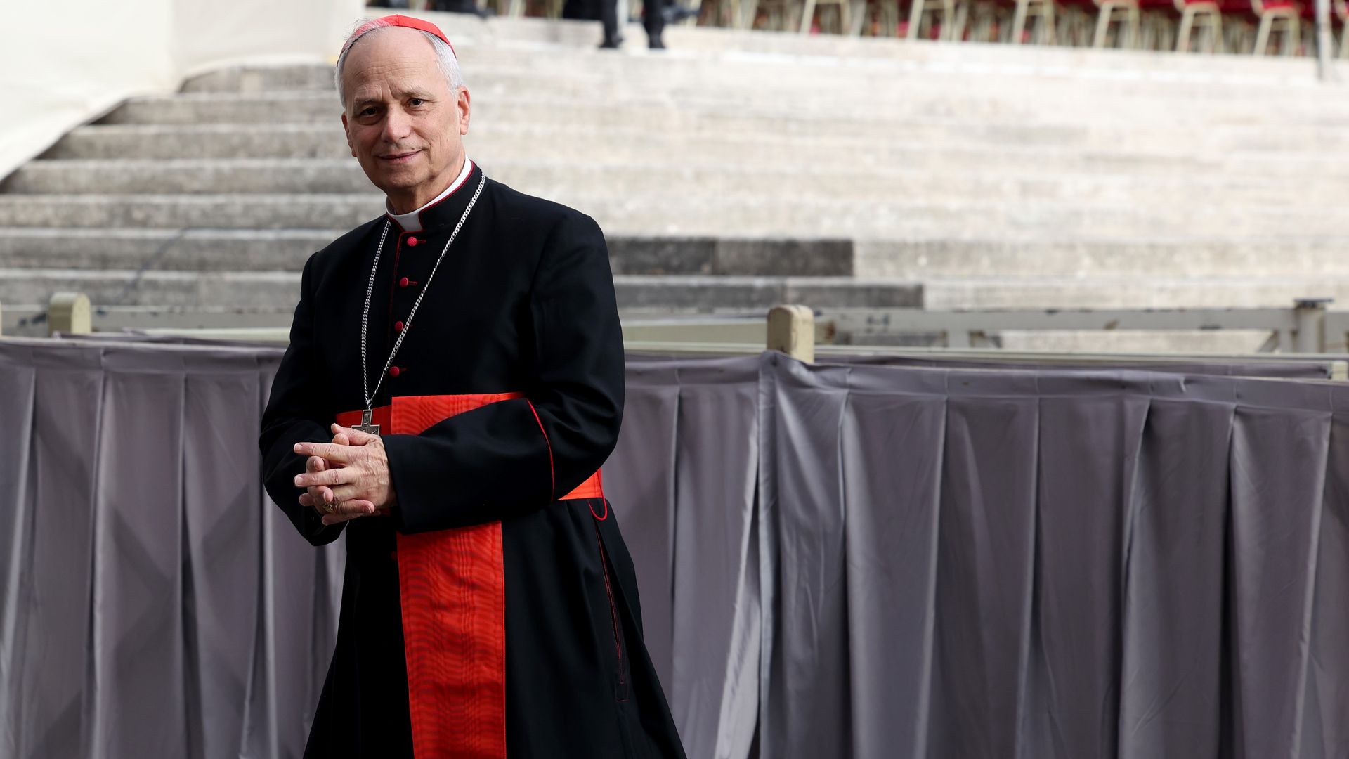 As cardinal, Pope Leo walks past the camera.
