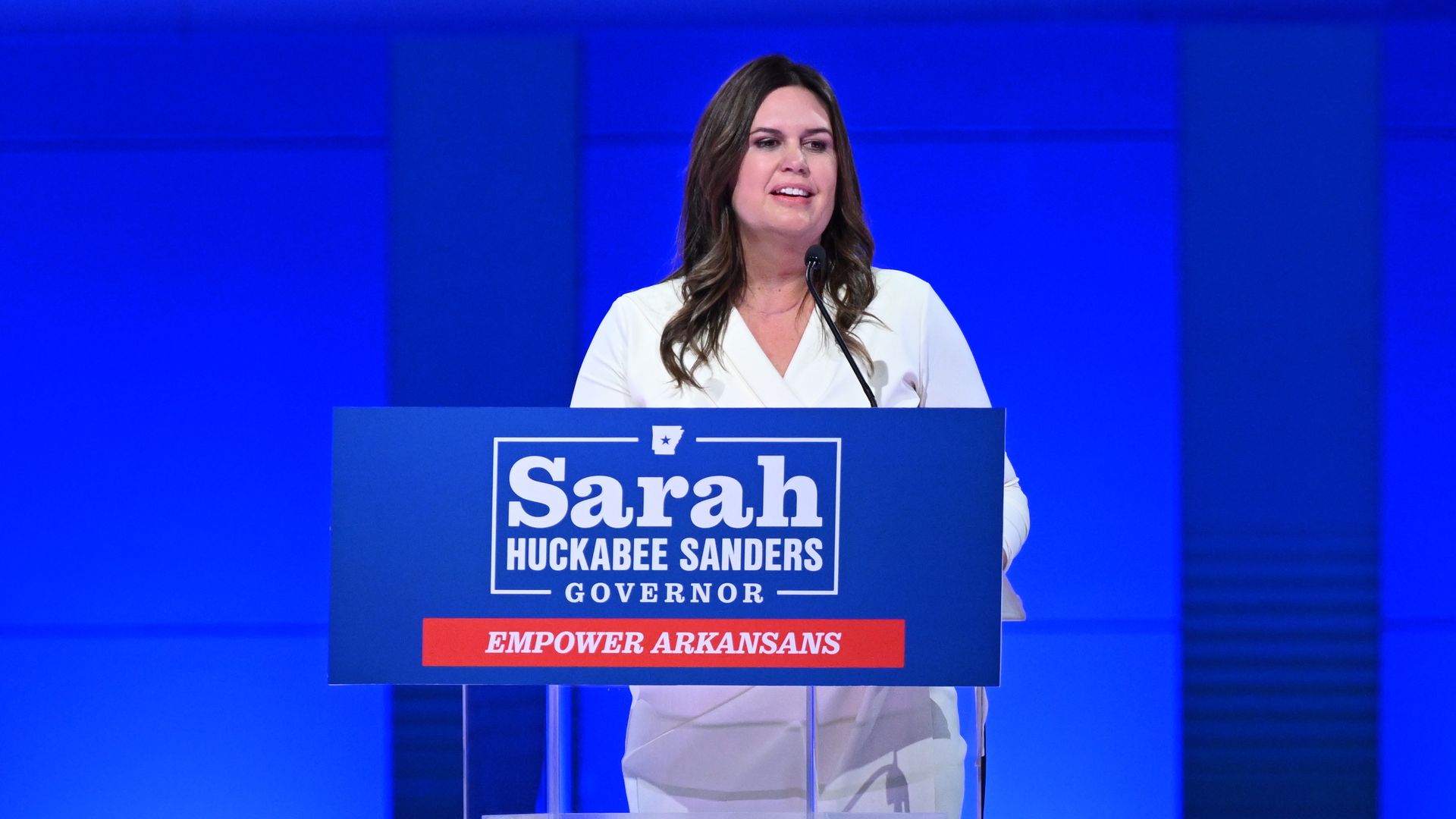 Arkansas Gov. Sarah Huckabee Sanders stands alone behind a podium giving her acceptance speech in Nov. 2022.