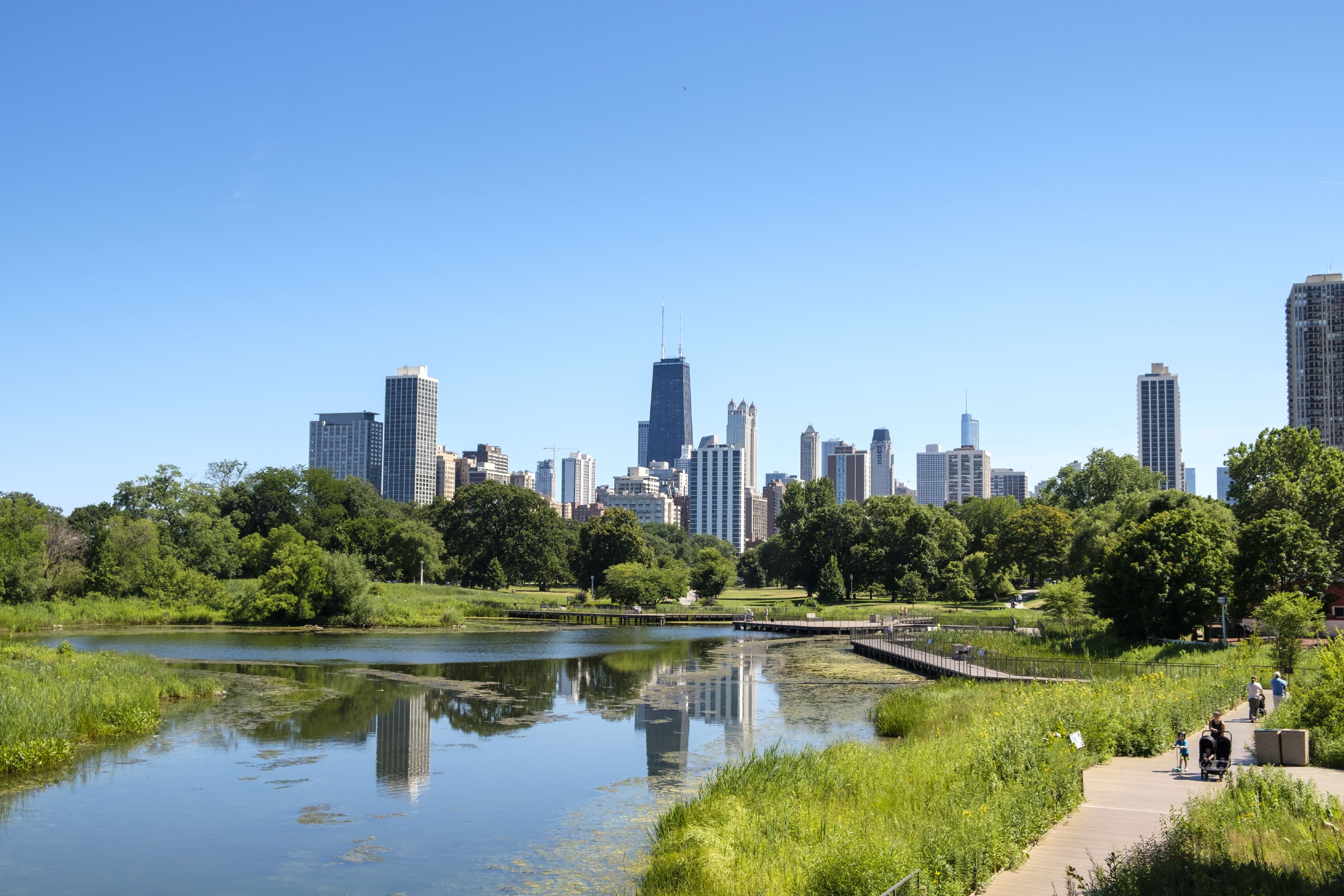 Photo of a skyline with a pond in front of it. 