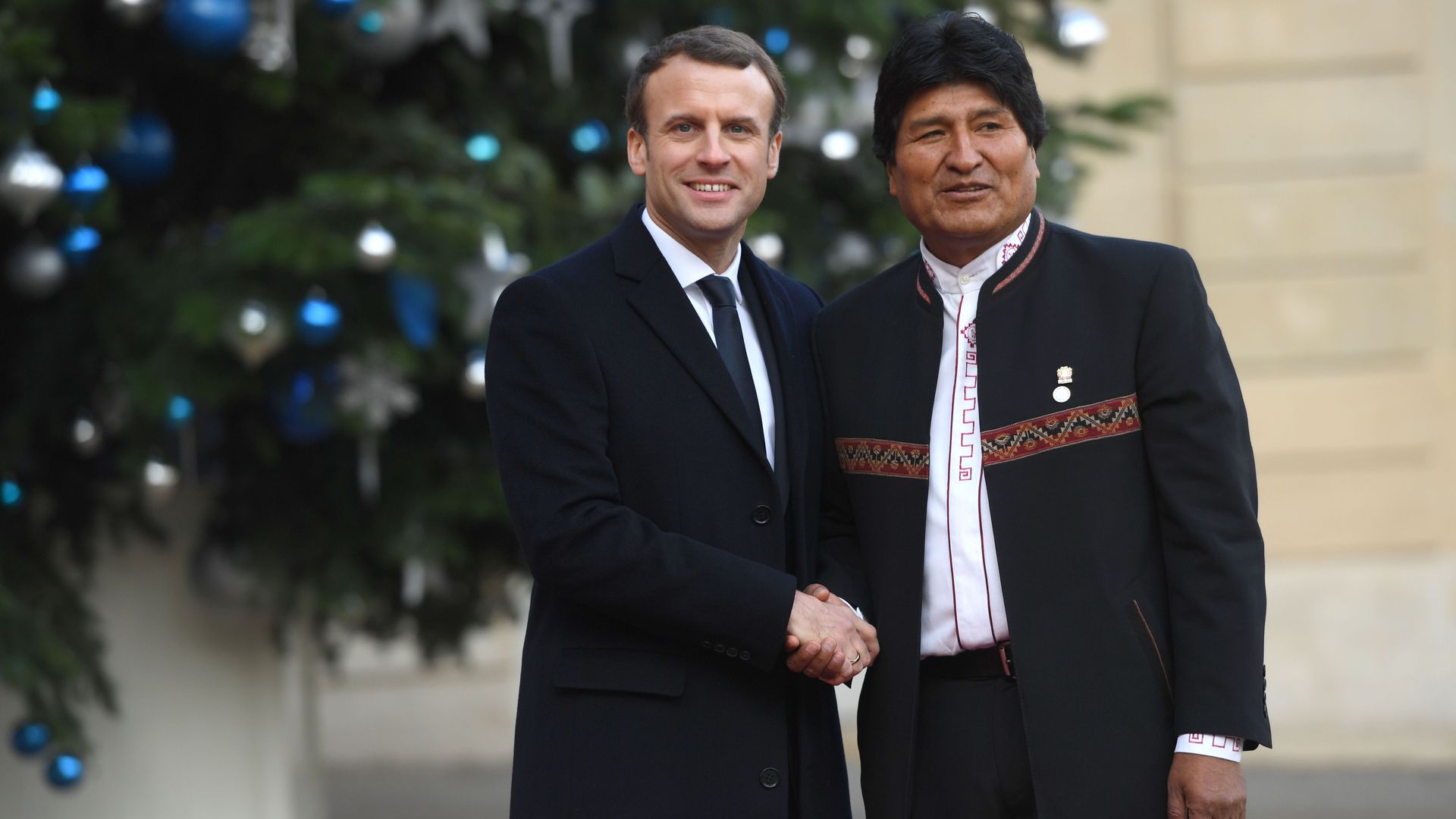 French President Emmanuel Macron greets Bolivian President Evo Morales upon his arrival at the Elysée palace on December 12, 2017.