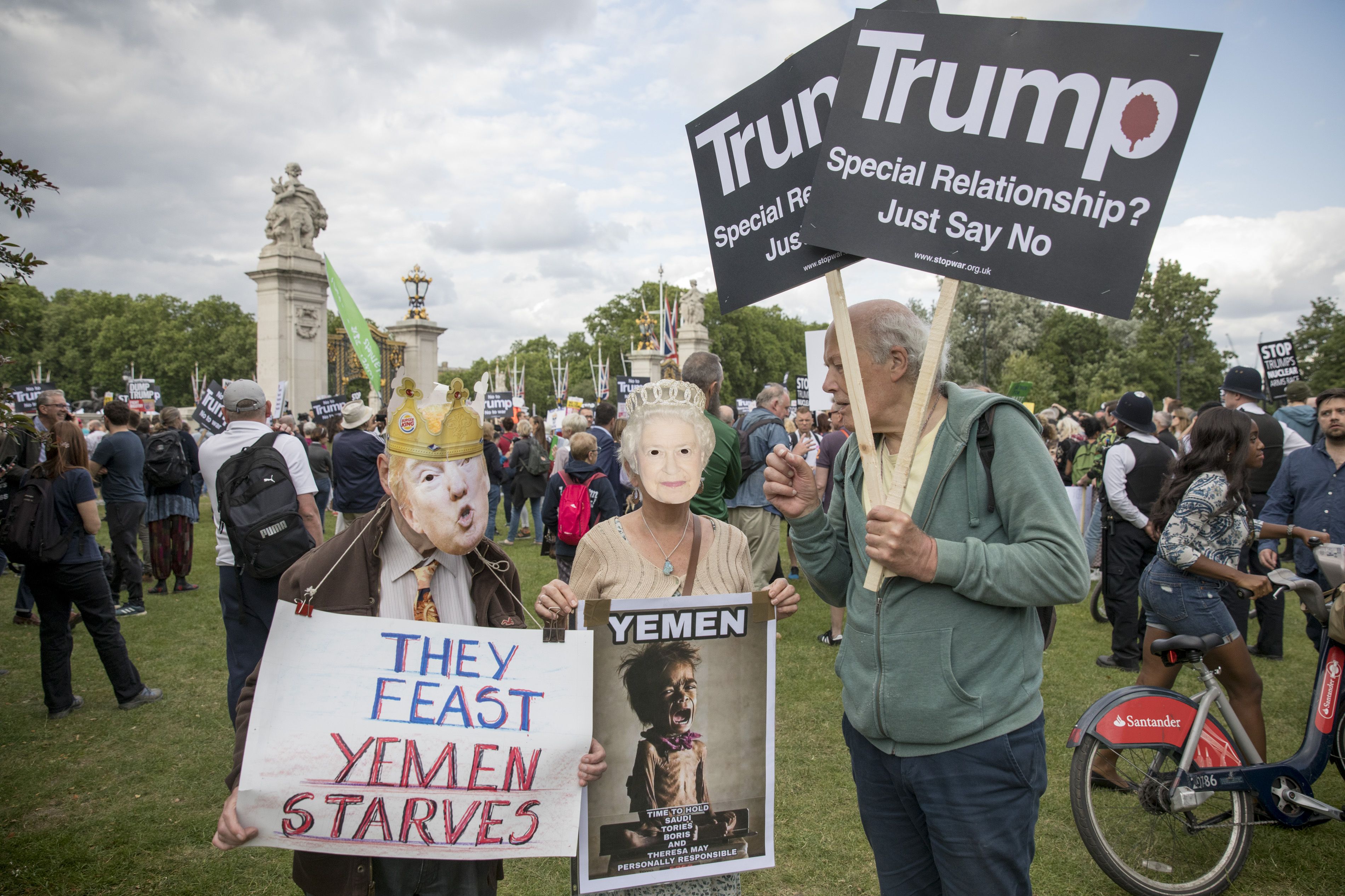 Demonstrators hold placards during a protest against Donald Trump's visit to the UK. 