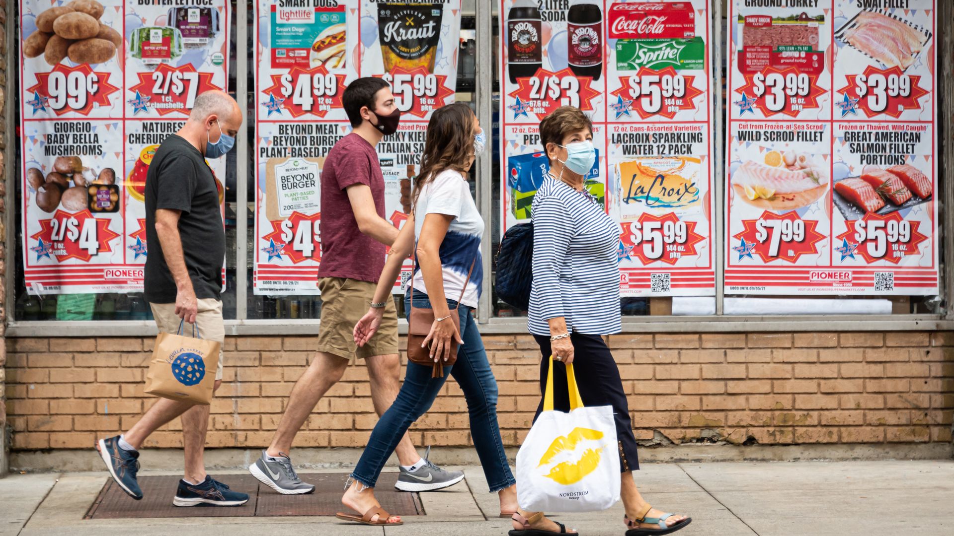 People wear face masks outside a supermarket on the Upper West Side during Labor Day Weekend on September 05, 2021