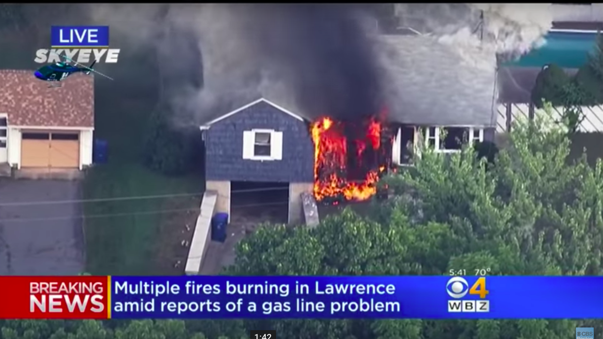 Flames consuming a home in Lawrence, Massachusetts. Photo via CBS Boston Youtube page.