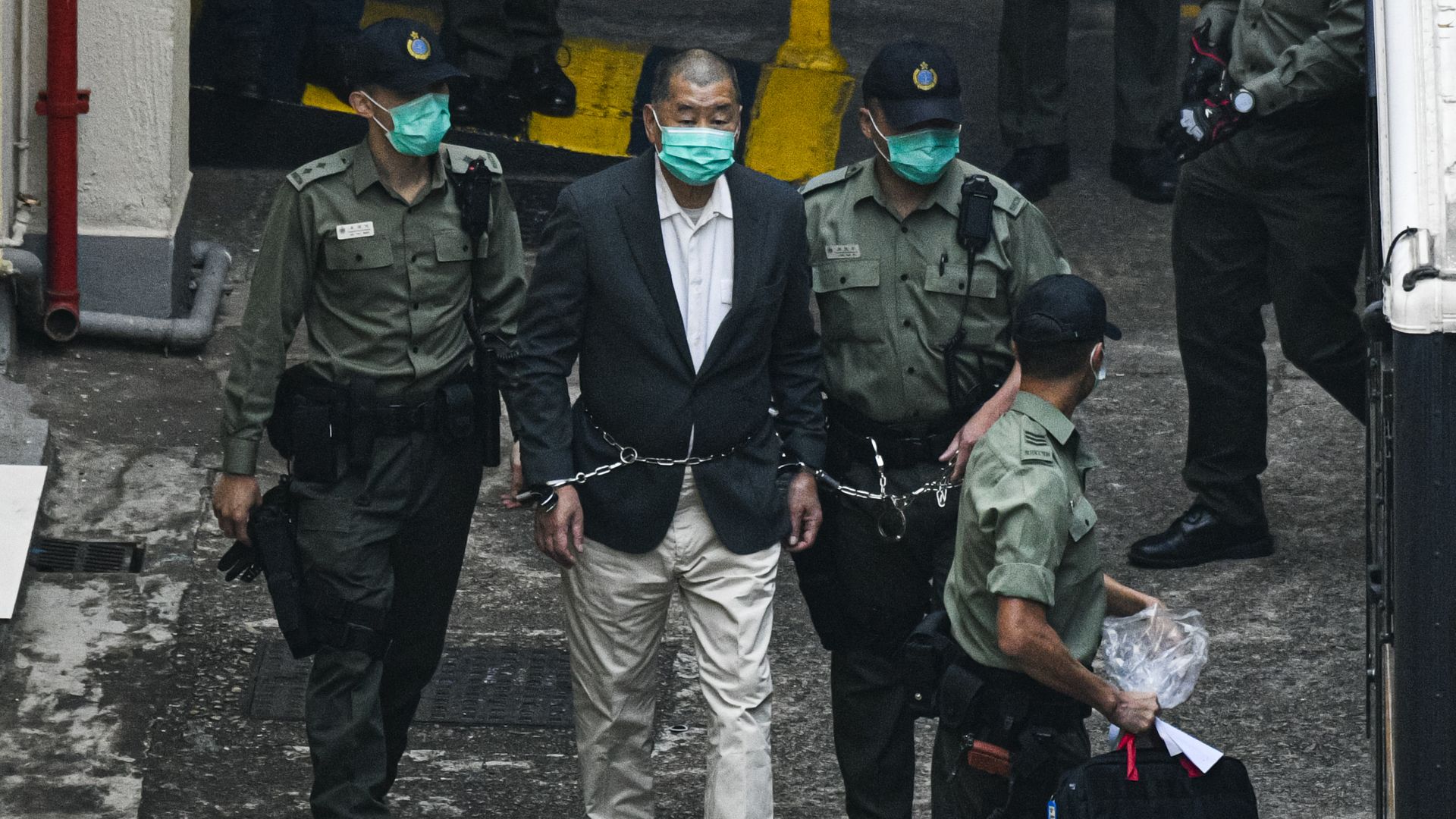 Jimmy Lai taken out in handcuffs.