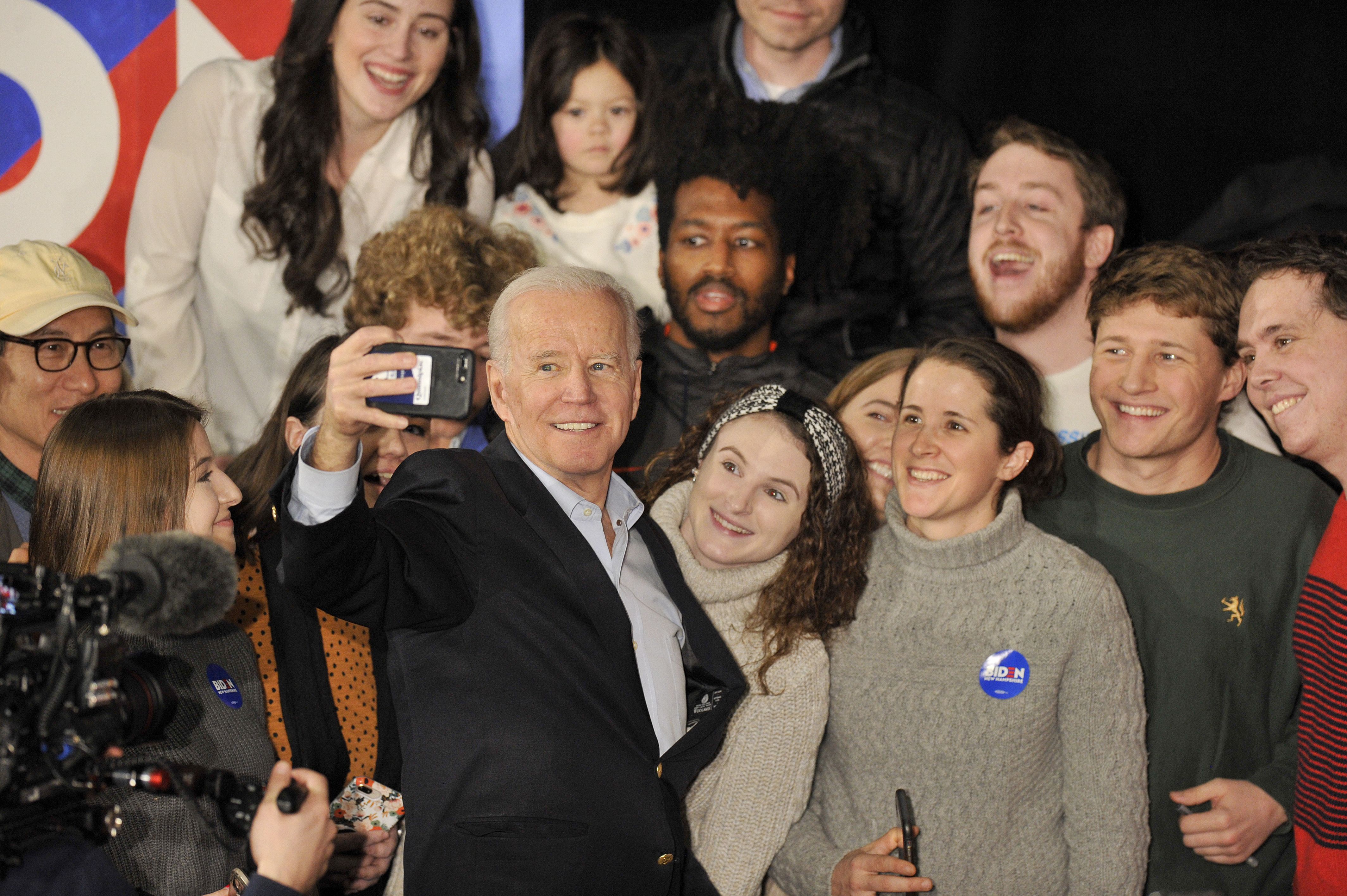 ormer Vice President Joe Biden takes selfies with supporters after speaking at a rally at the Rex Theatre in Manchester, New Hampshire on February 8