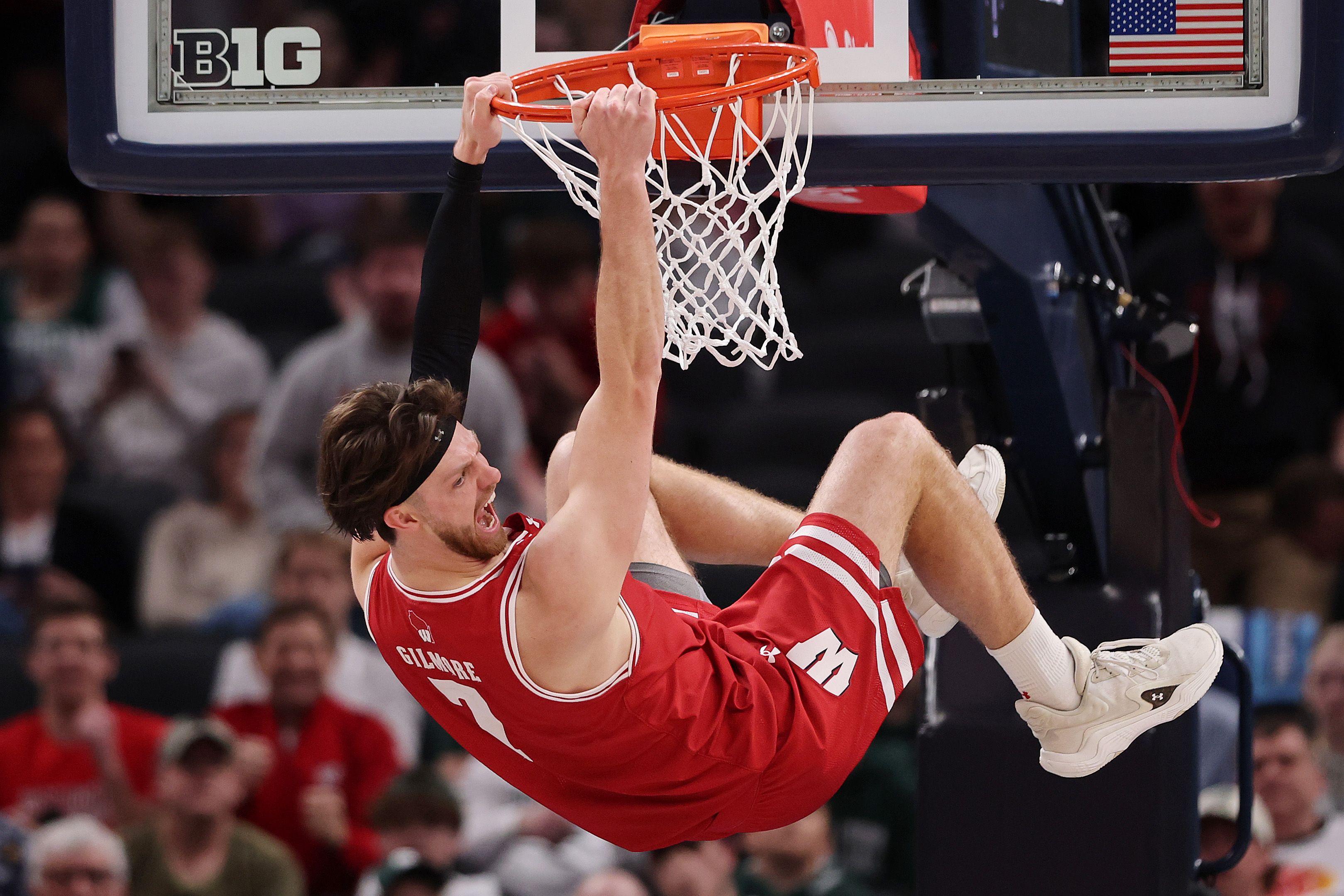 Photo of a man dunking a basketball during a game. 