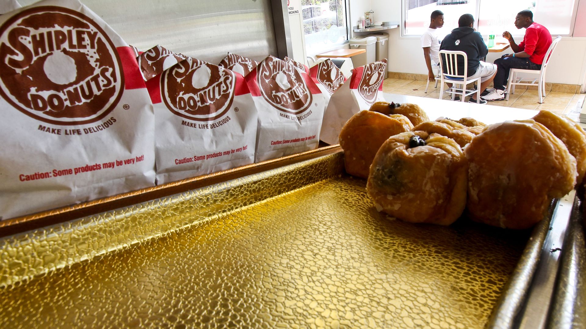 Photo of Shipley donuts next to a stuffed bags with the company branding. 