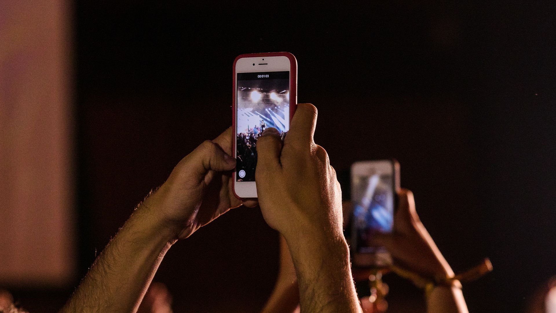 Concert-goers record a show on their phones