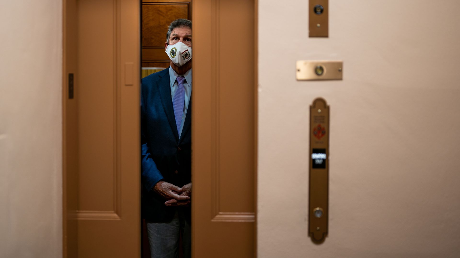 An elevator door closes at the Capitol with Sen. Joe Manchin inside