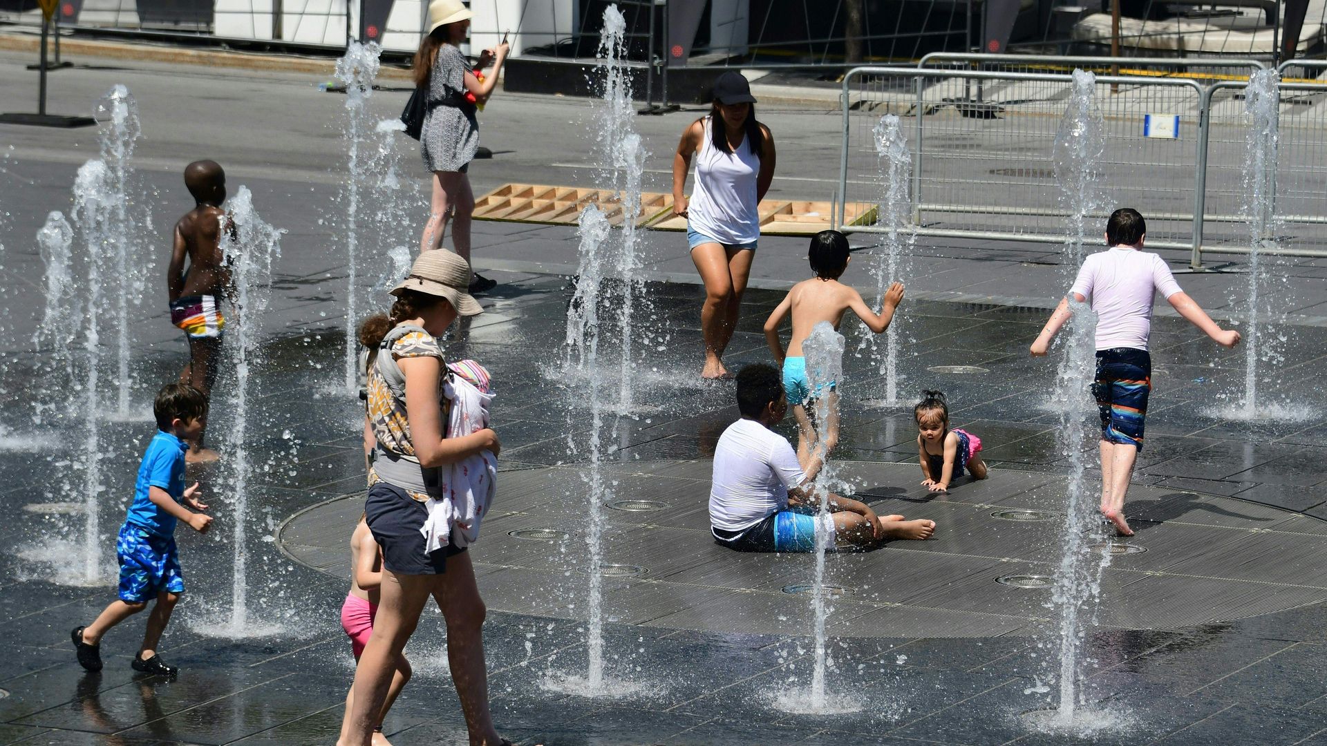 Montrealers play in a city water fountain this week