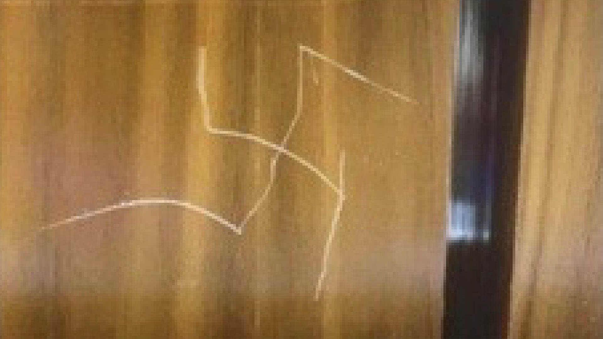 A swastika is seen etched into the wall of a State Department elevator.