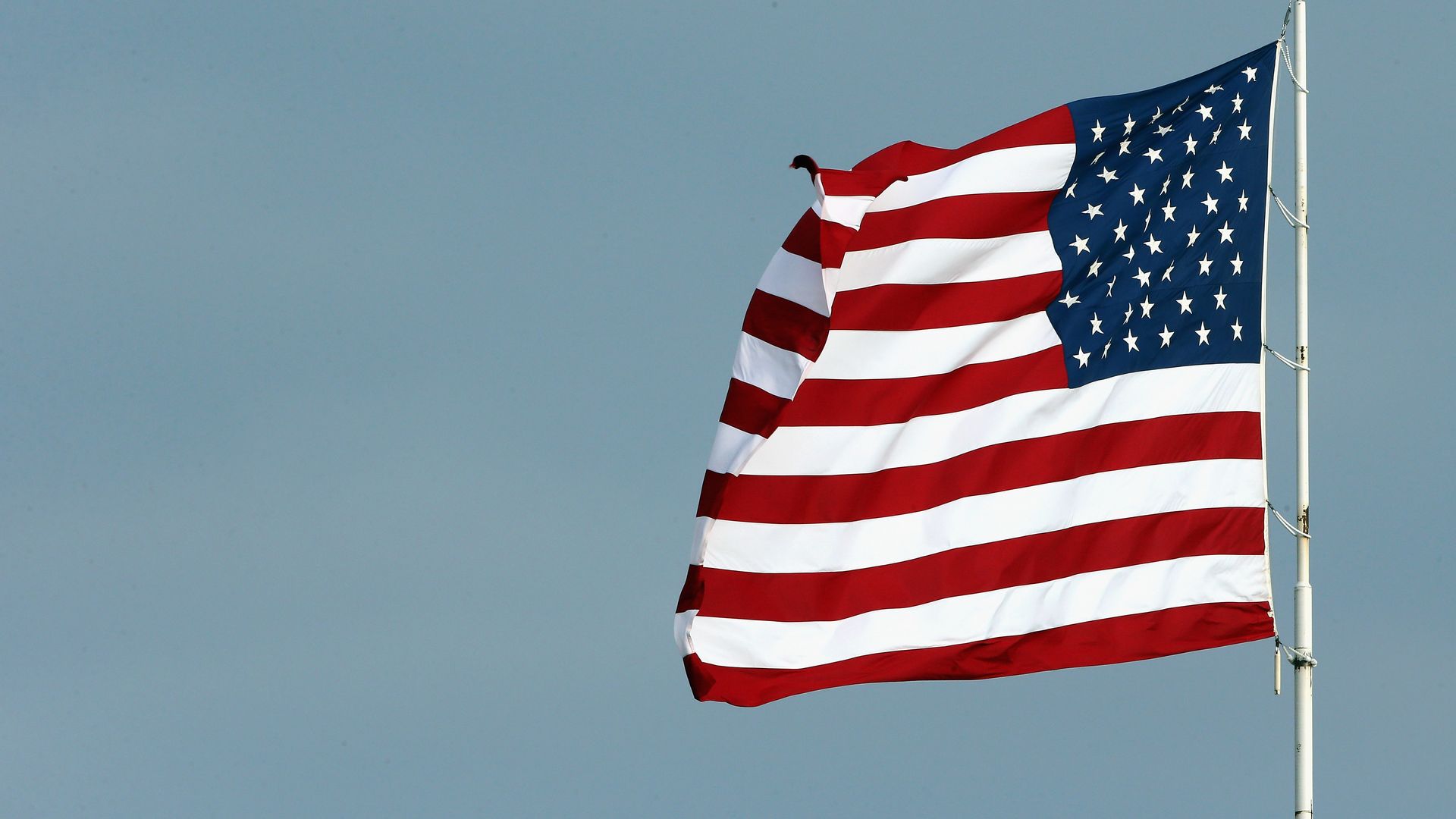 The American flag waves during the national anthem prior to the Monster Energy NASCAR Cup Series KC Masterpiece 400 at Kansas Speedway on May 12, 2018 in Kansas City, Kansas.