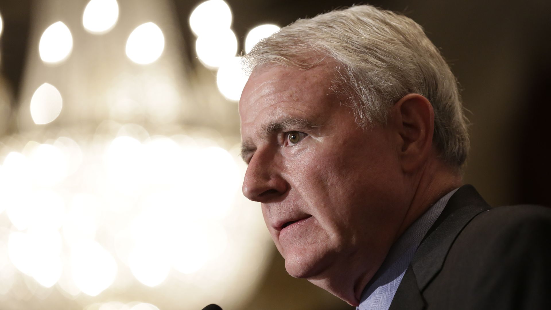 In this image, Tom Barrett stands