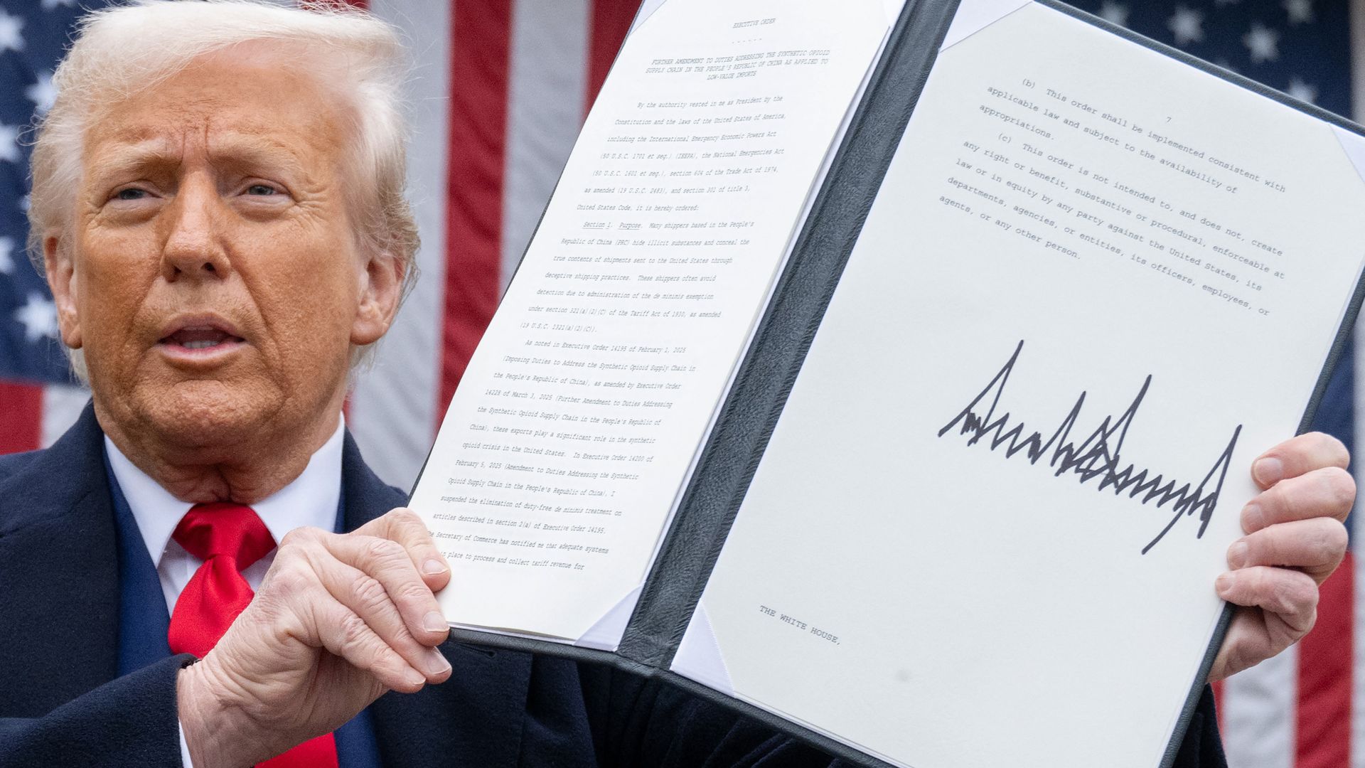 Trump holds up document showing reciprocal tariffs at an event in the Rose Garden