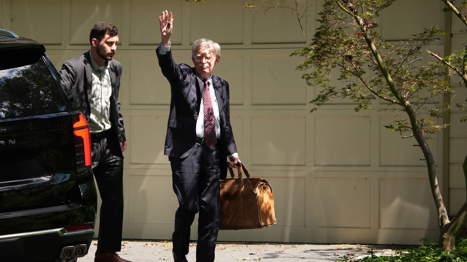 John Bolton, former national security adviser to President Trump, waves as he arrives home as the FBI searches his house on Aug. 22 in Bethesda, Maryland. Photo: Andrew Harnik/Getty Images