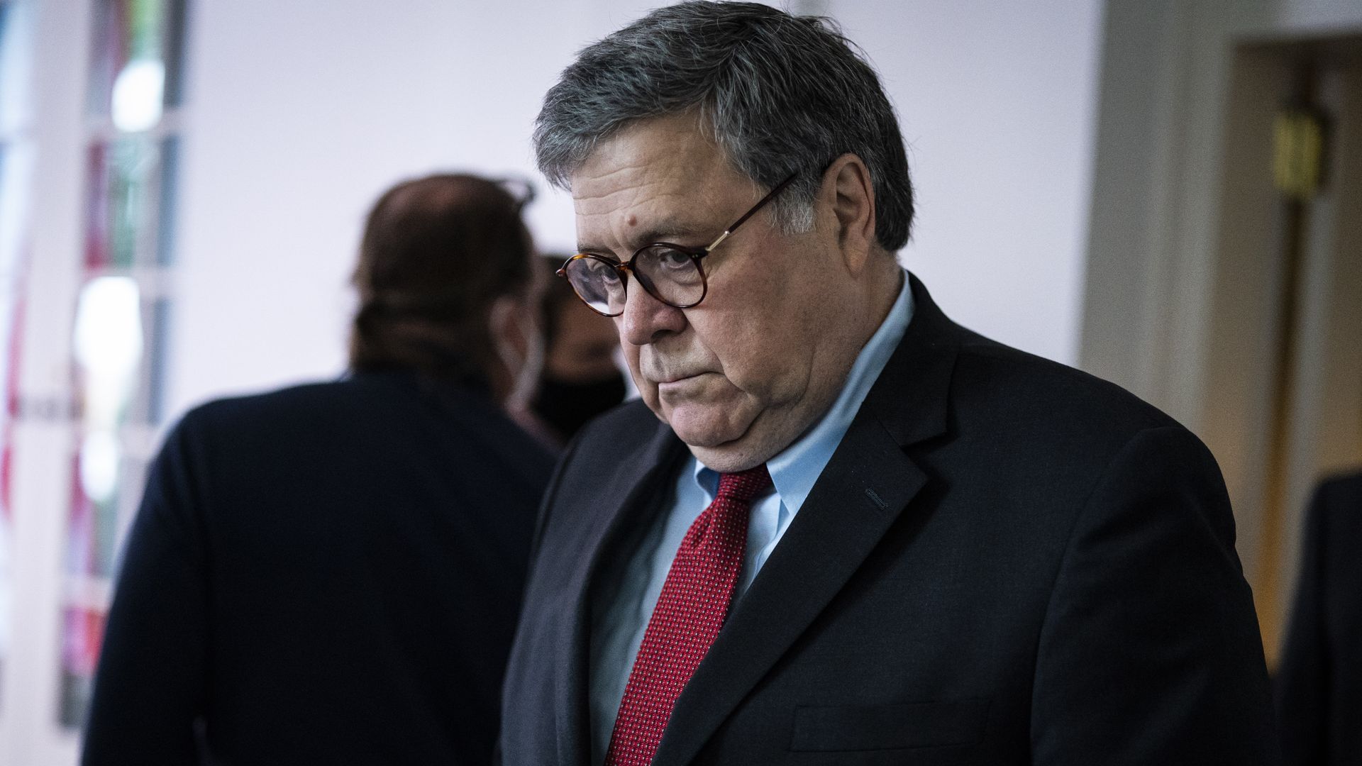 Attorney General Bill Barr stares into space at a ceremony 