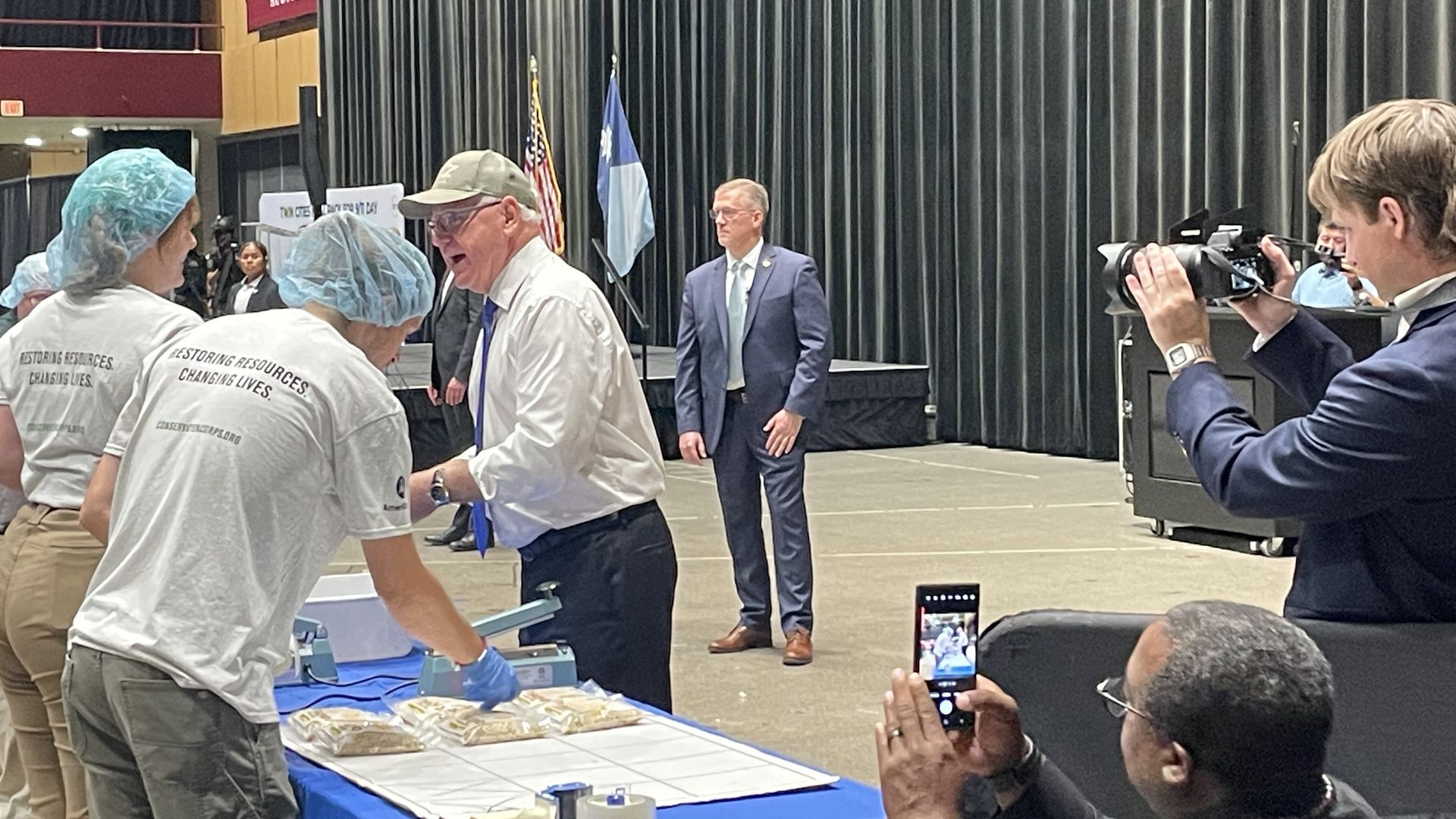 walz in a hat pacing meals at an event