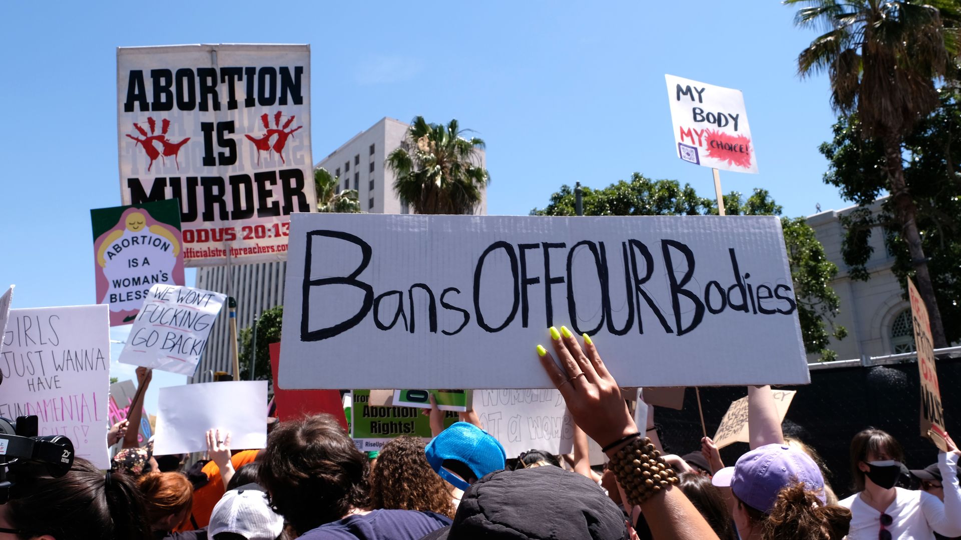 Picture of signs that are in support of abortion rights and others that are anti-abortion