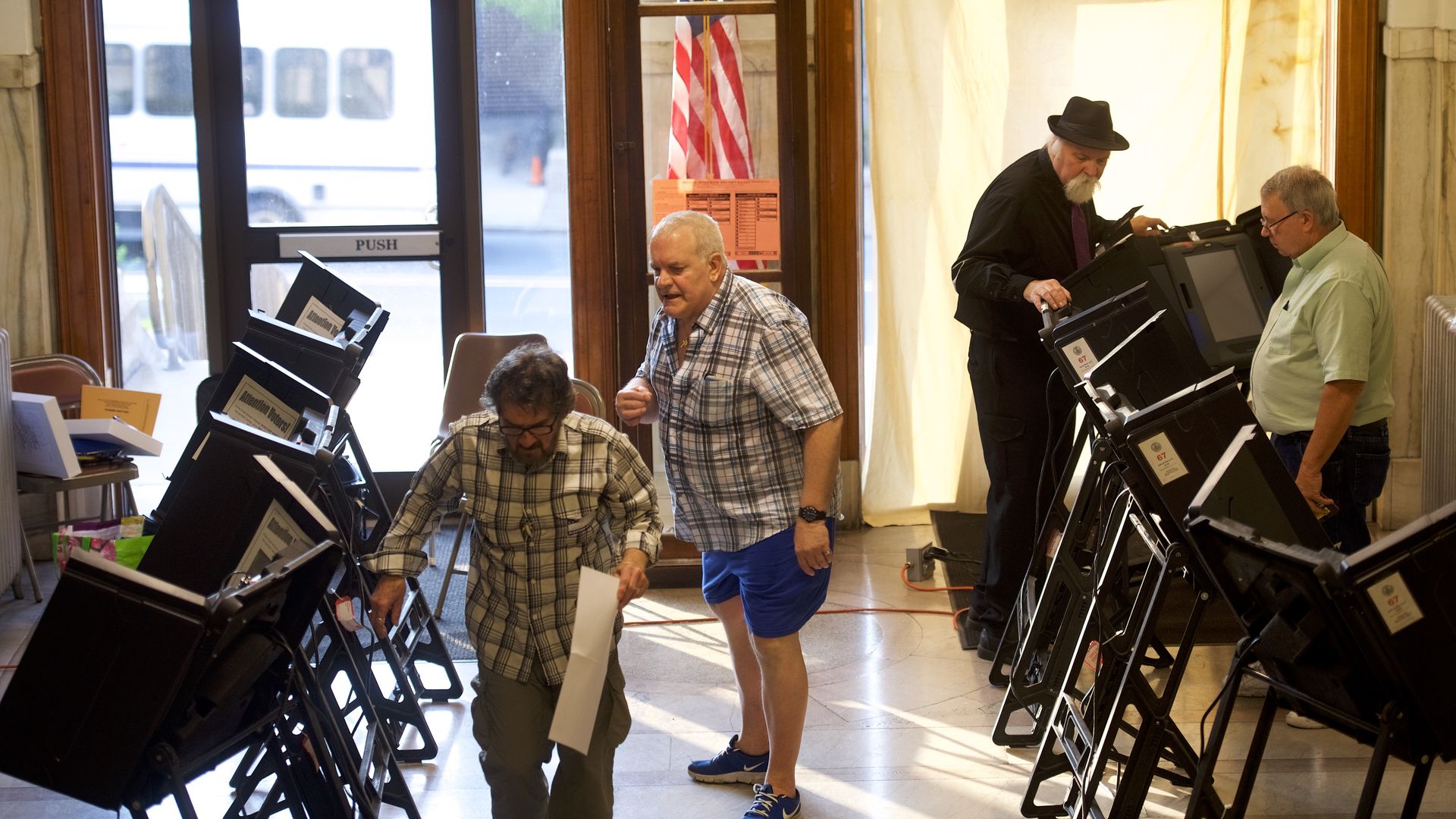 Election officials prepare voting booths in the 2018 Pennsylvania Primary Election
