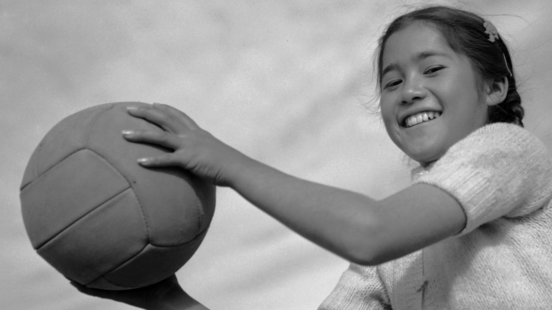 A Japanese American girl with volleyball in the WWII-era Manzanar Relocation Center, Calif., in 1943. 