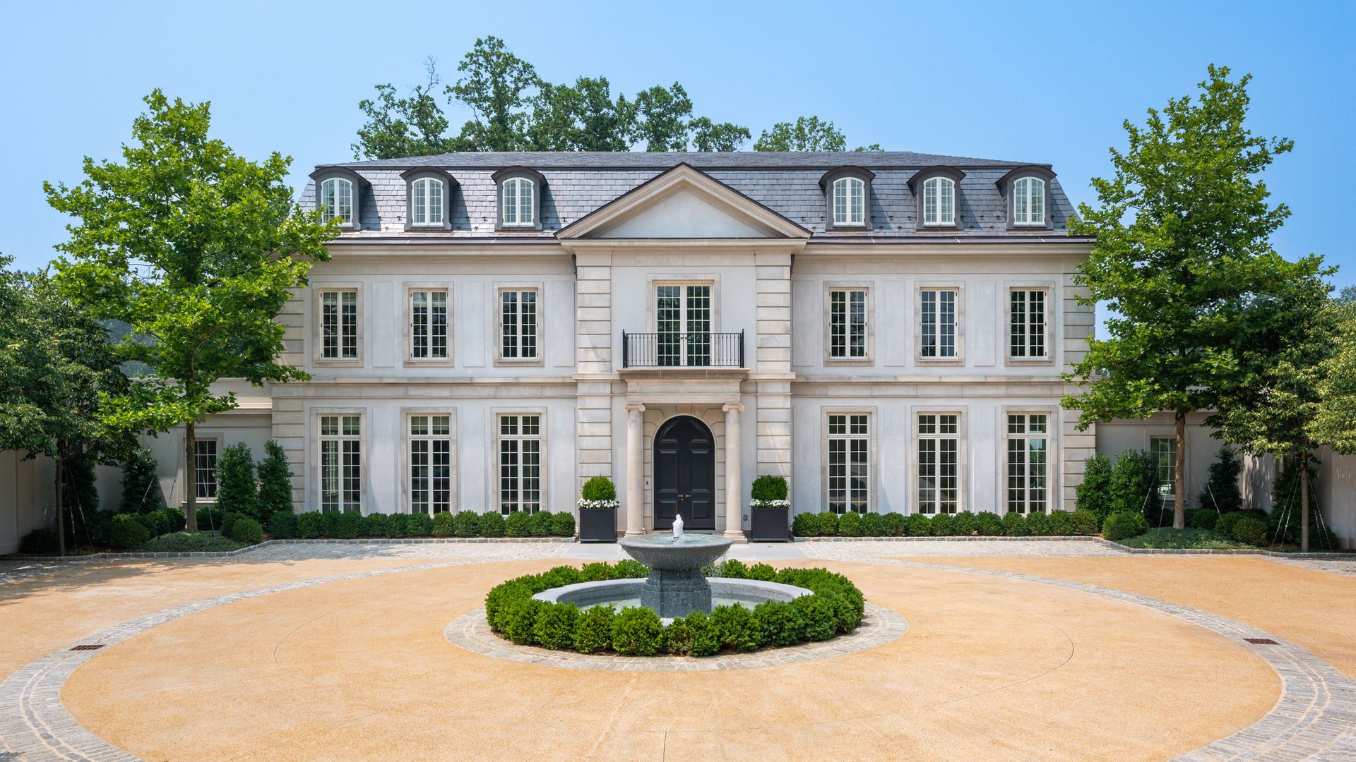 A photo of a large home in Washington, D.C., with a fountain in front.