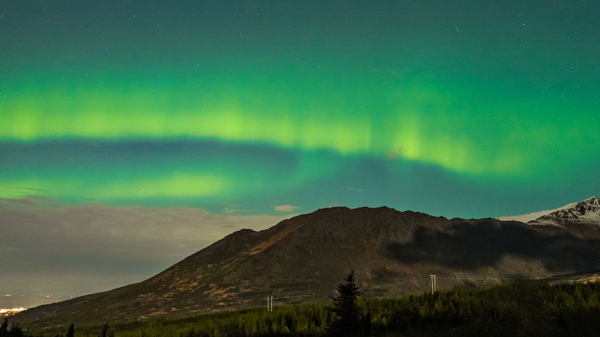 Northern lights in shades of green and blue appear in the sky