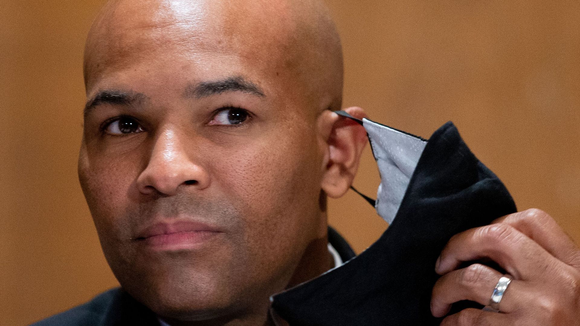 US Surgeon General Jerome Adams takes off his face mask as he appears before a Senate Health, Education, Labor and Pensions Committee hearing on September 9