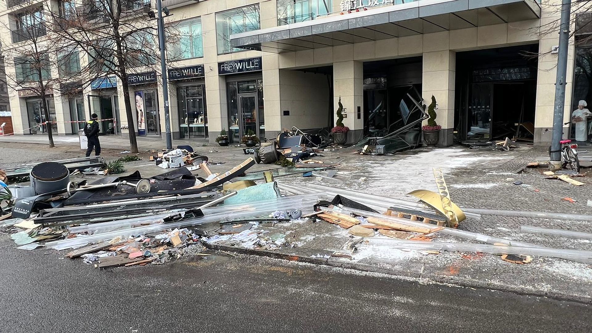 Debris lie around in front of the Radisson Blu hotel, where a huge aquarium located in the hotel's lobby burst on December 16, 2022 in Berlin, Germany.